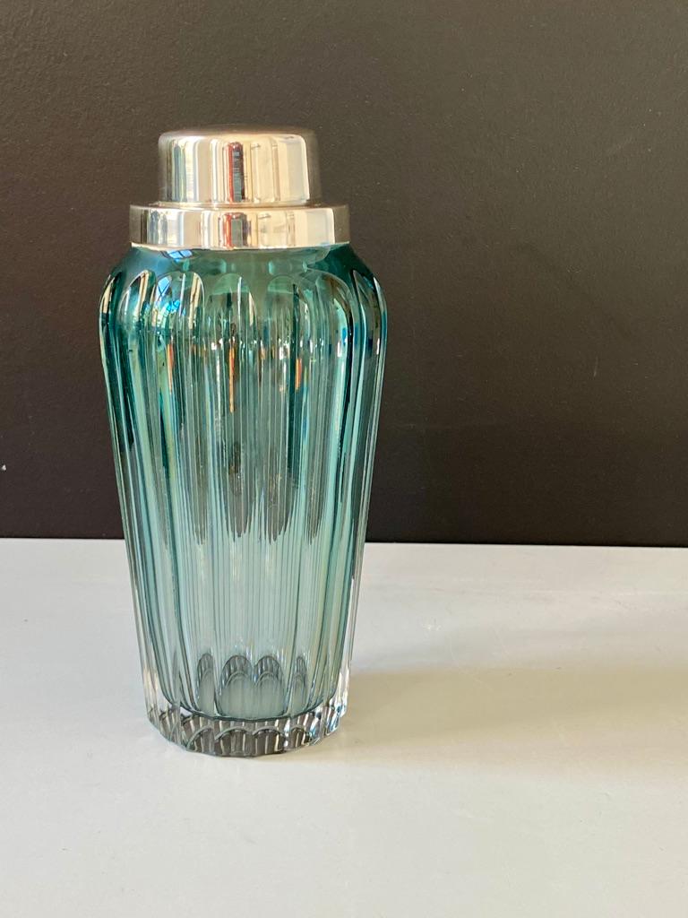 The mouth blown and hand carved glass shaker is inspired from the turn of the century designs and comes with mounted silver plated lid and built in strainer for contemporary use.
Fy-shan Glass Studio seeks to create timeless pieces that represent