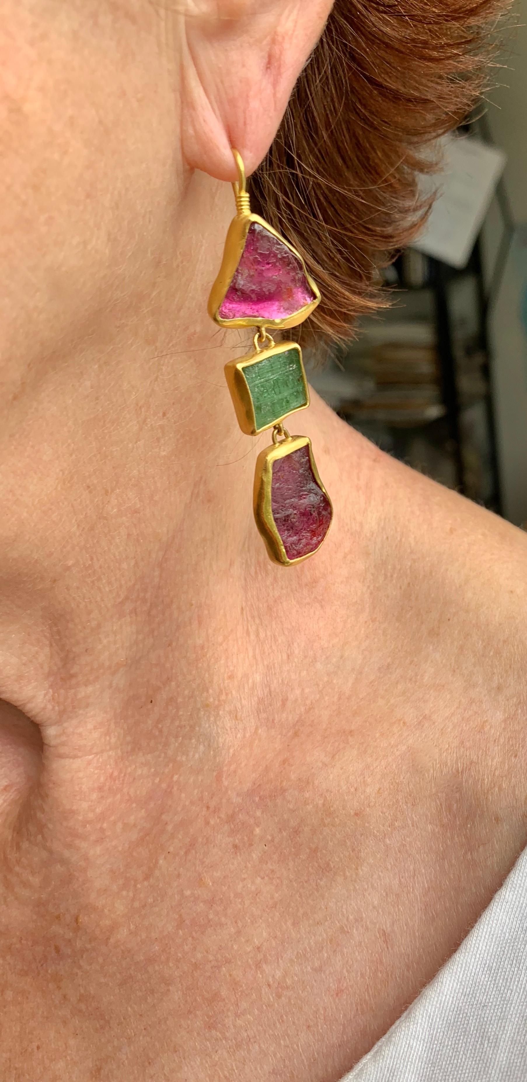 Arguably the most colorful of all gemstones, these tourmalines certainly do not disappoint. Free form pink and green tourmalines weighing 46.70 carats, have been delicately set in a 22 karat gold organic shaped bezel, 20 karat gold ear wire.