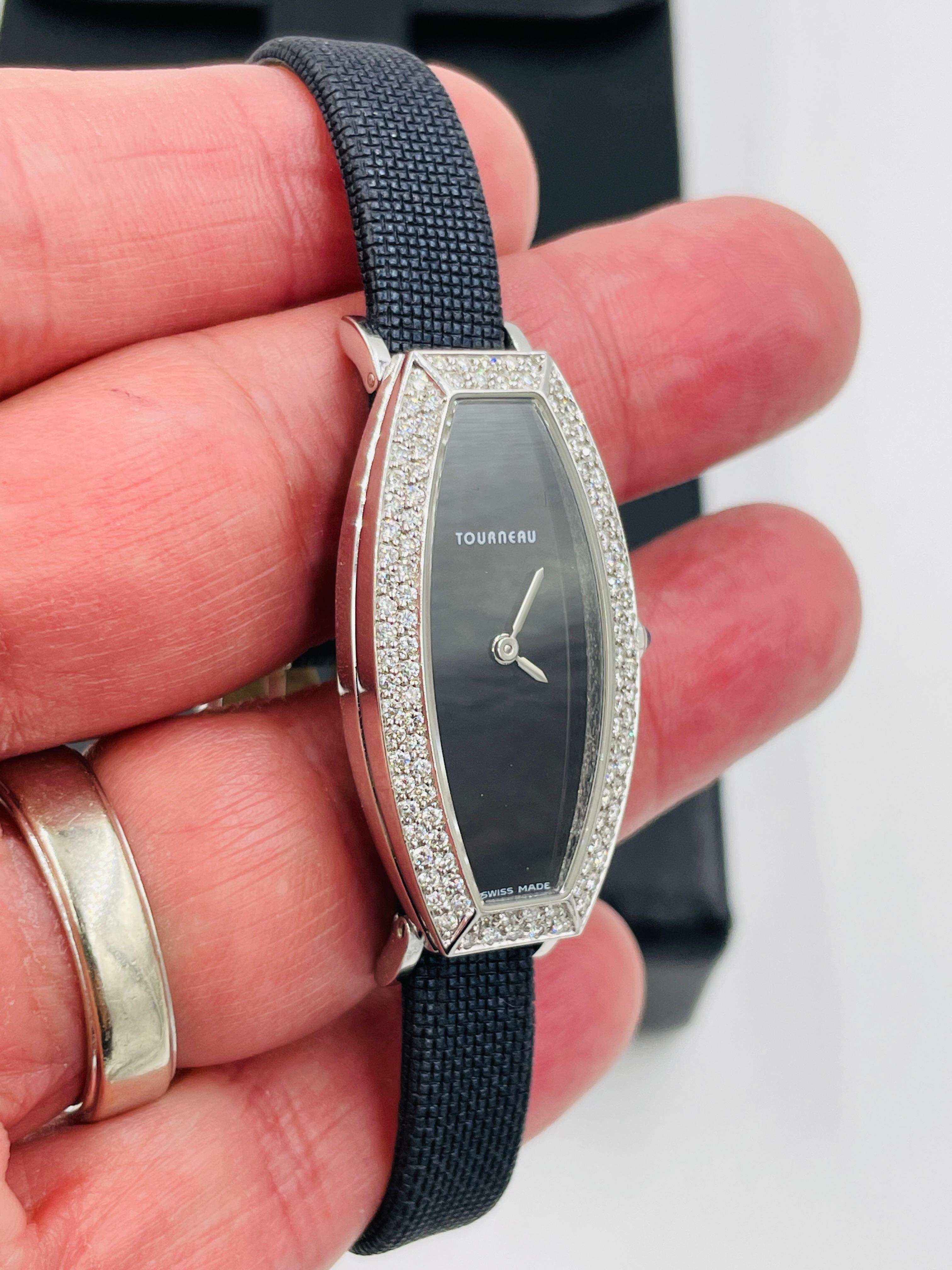 Ladies Tourneau Diamond White Gold Wristwatch with a black strap.
In beautiful condition this ladies Tourneau 18k White Gold Watch measures approximately 1