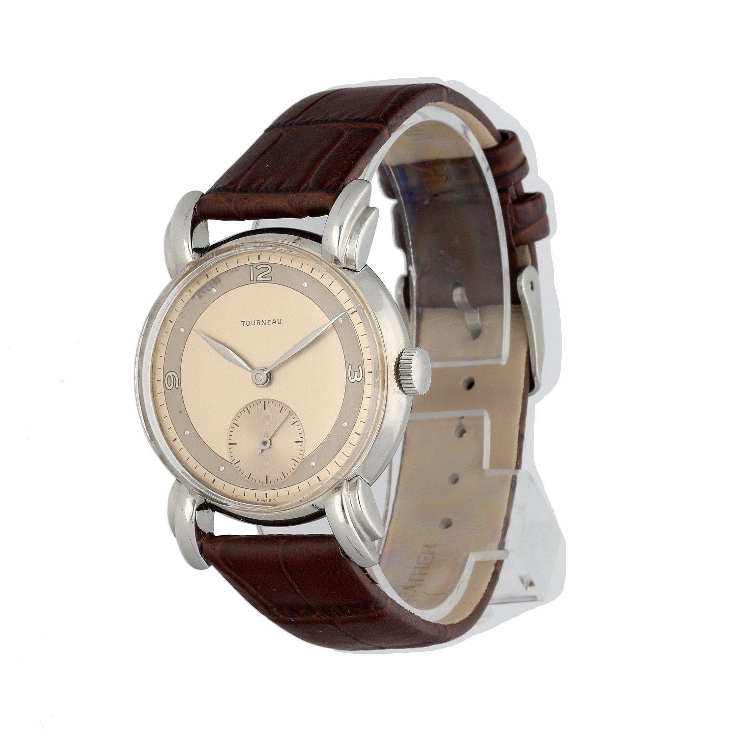 Tourneau men's watch. 34MM stainless steel case. Light Bronze dial with Arabic numeral hour marker. Minute markers on the outer dial and small second display at 6 o'clock position. Acrylic crystal and stainless steel case back. Brown leather with