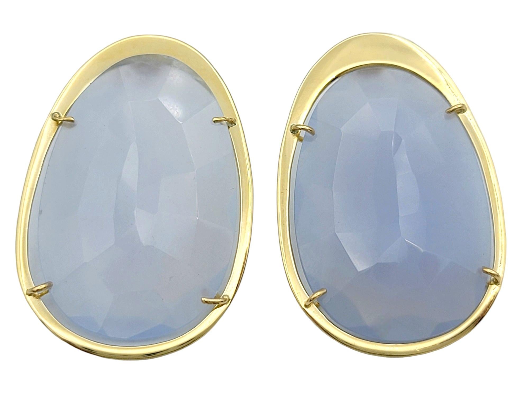 Discover the timeless beauty of Tous with these exquisite 46 carat faceted oval chalcedony pierced earrings, set in luxurious 18 karat yellow gold. Each earring features a stunning, faceted oval chalcedony stone that captures the light beautifully,
