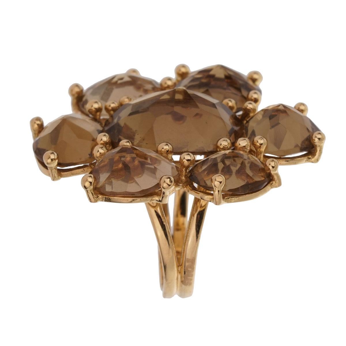 A very chic Tous ring featuring 7 Smokey Quartz stones inversely set to create a one of kind design in 18k yellow gold. The ring measures a size 6 1/2 and can be resized.

Sku: 1943