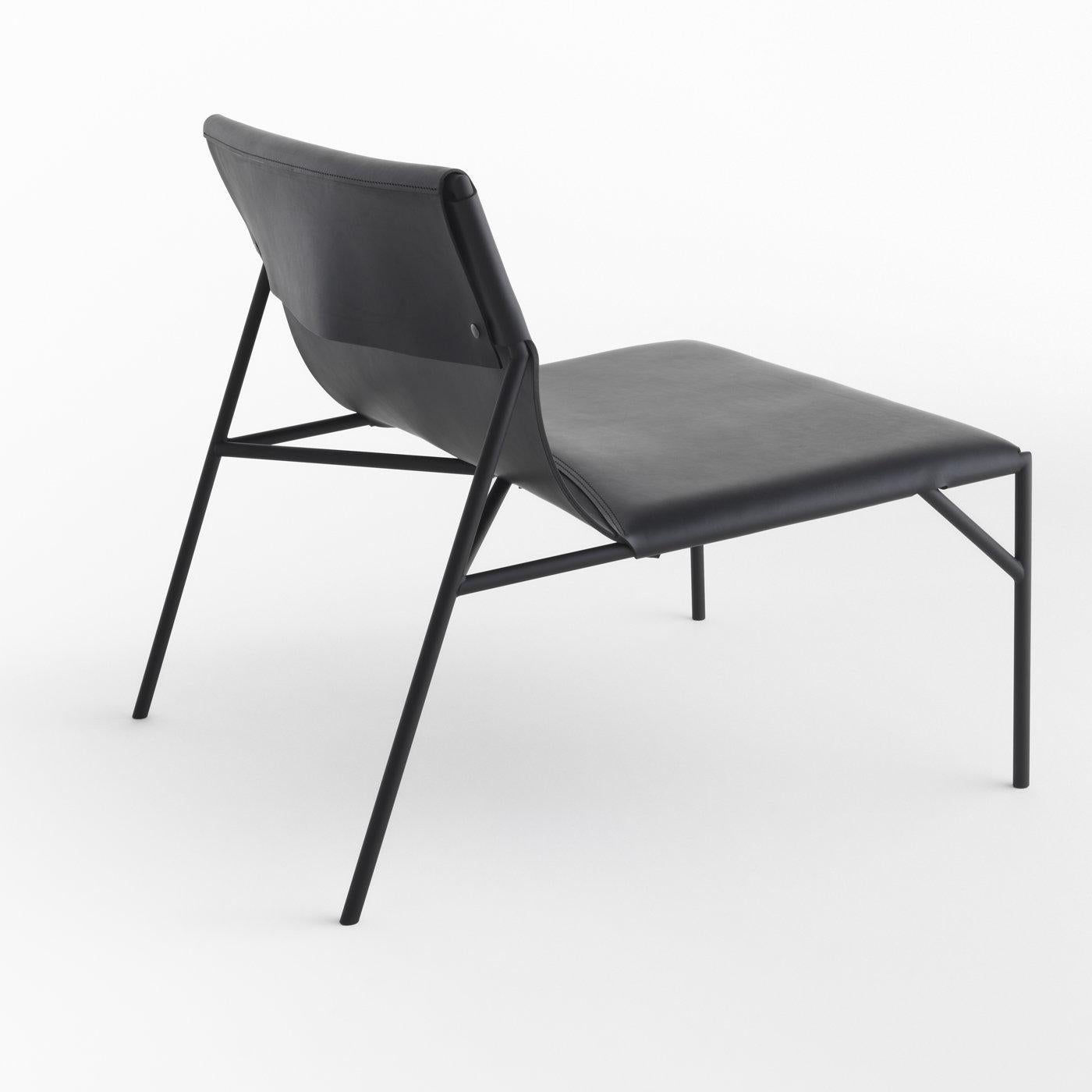 Delicately resting on a robust black-finished metal structure, this lounge chair designed by Marc Thorpe has an elegant and essential silhouette. The extended seat (40 cm height) is upholstered in black leather, and features a slanted backrest that