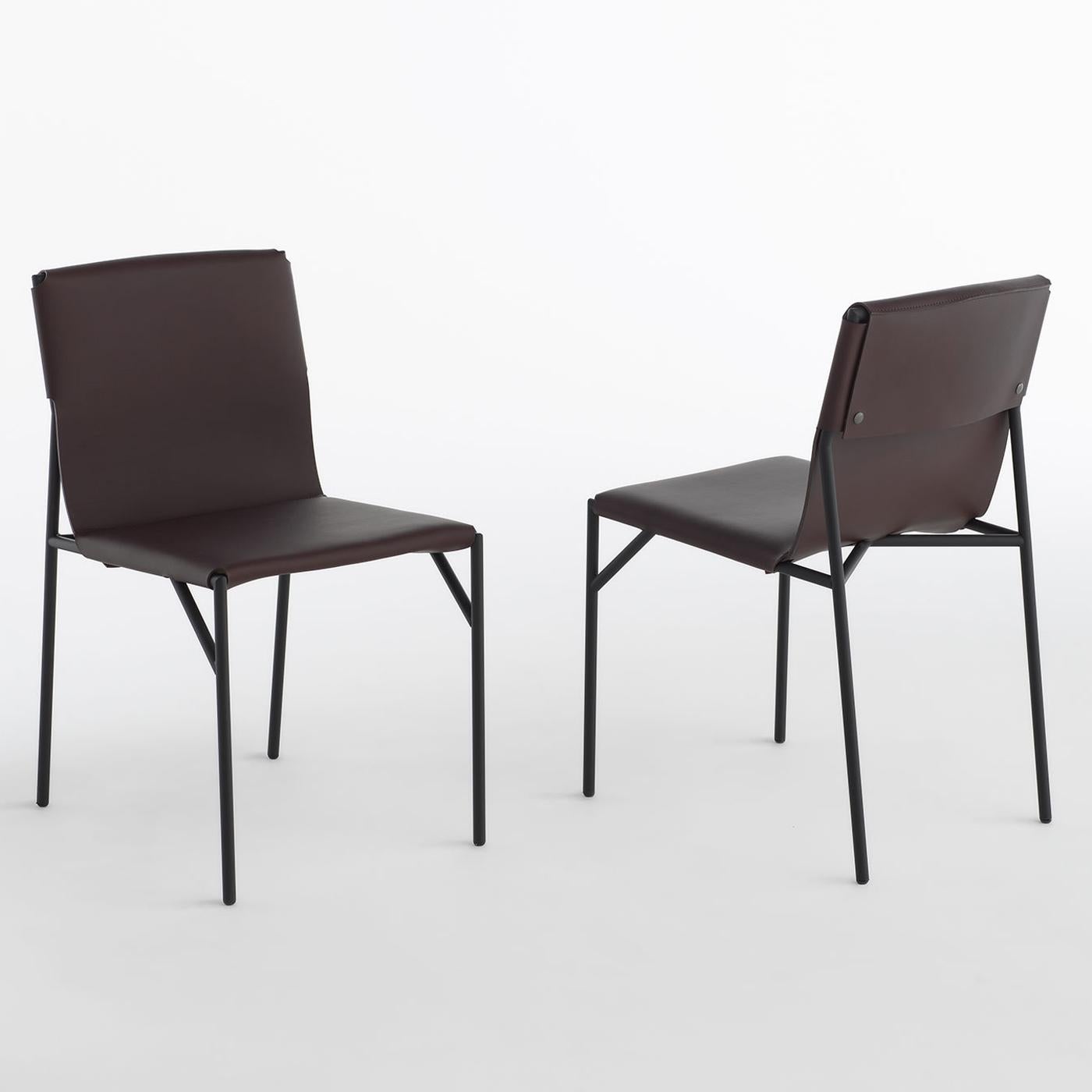 Minimalism and elegance are distinctive features of this versatile piece of functional decor. Boasting a modern silhouette, this chair is exquisitely designed by Marc Thorpe with a slim yet robust metal structure finished in matte black. The