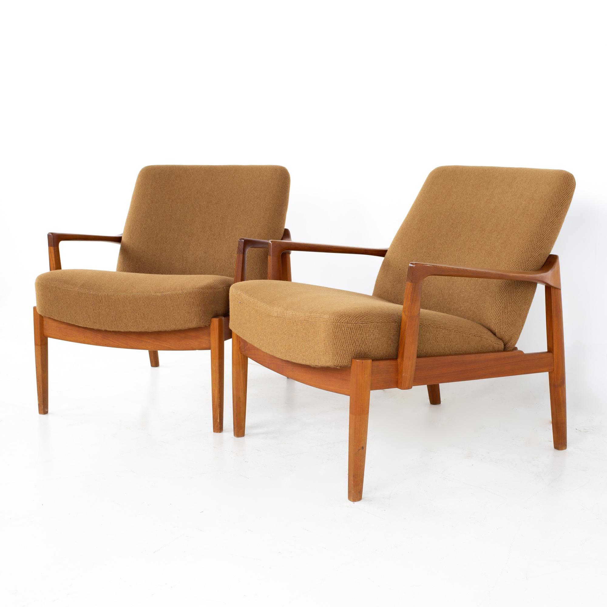 Tove and Edvard Kindt-Larsen for John Stuart France and Sons mid century Danish teak lounge chairs - a pair.
Each chair measures: 30 wide x 29 deep x 30 high, with a seat height of 18 inches and arm height of 21.5 inches

All pieces of furniture