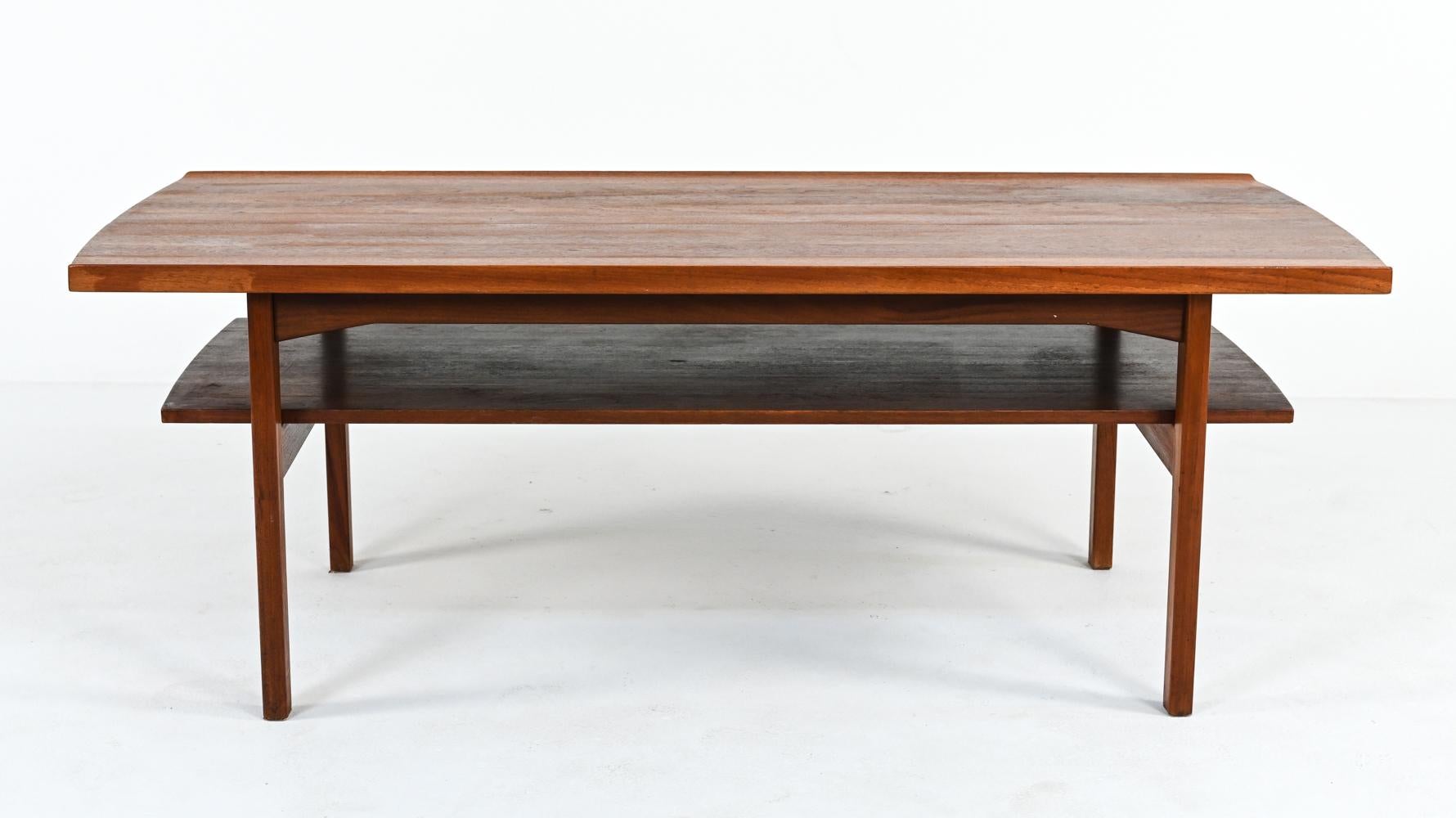Situated at the perfect height for board games or cocktails, this beautiful table represents the pinnacle of Scandinavian craftsmanship and design. Its two tiers are crafted from solid teak panels and joined by visible tenons. The top is sculpted
