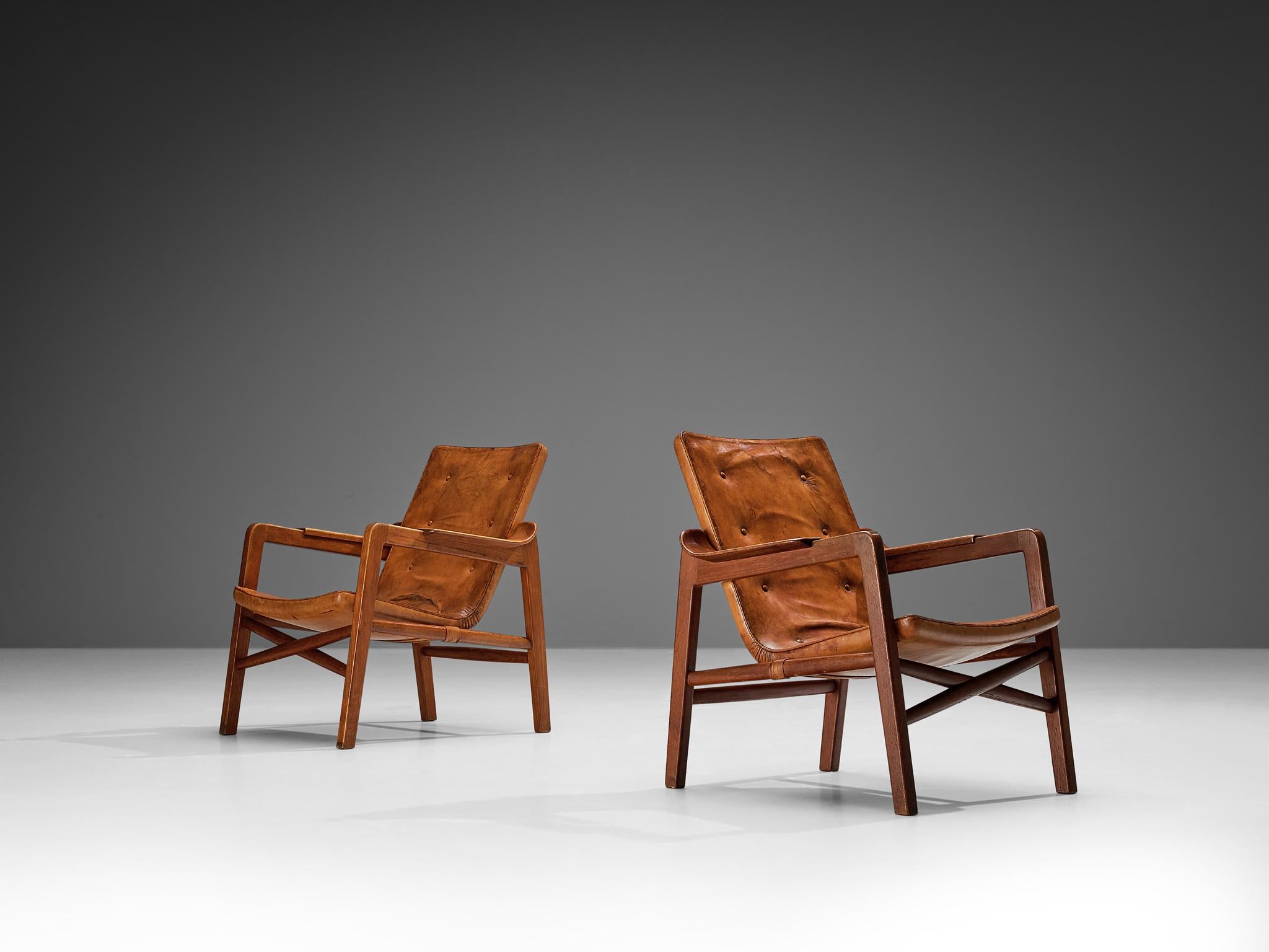 Tove & Edvard Kindt-Larsen for Gustav Bertelsen, pair of lounge chairs 'Fireplace', teak, leather, Denmark, 1940 

These Danish lounge chairs were meticulously crafted for the purpose of accompanying a fireplace, evoking a sense of warmth and