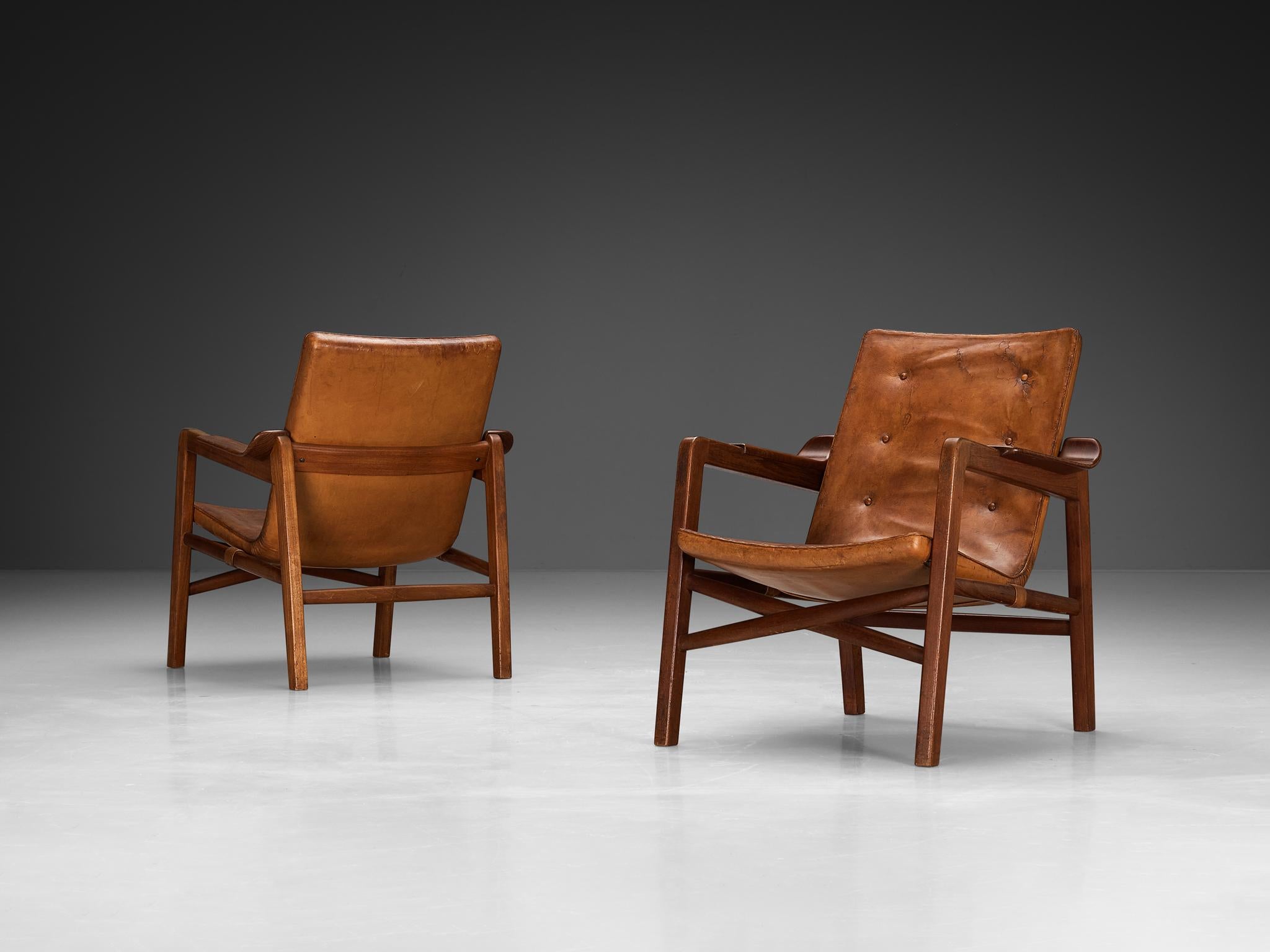 Tove & Edvard Kindt-Larsen for Gustav Bertelsen, pair of lounge chairs 'Fireplace', teak, leather, Denmark, 1940 

These Danish lounge chairs were meticulously crafted for the purpose of accompanying a fireplace, evoking a sense of warmth and
