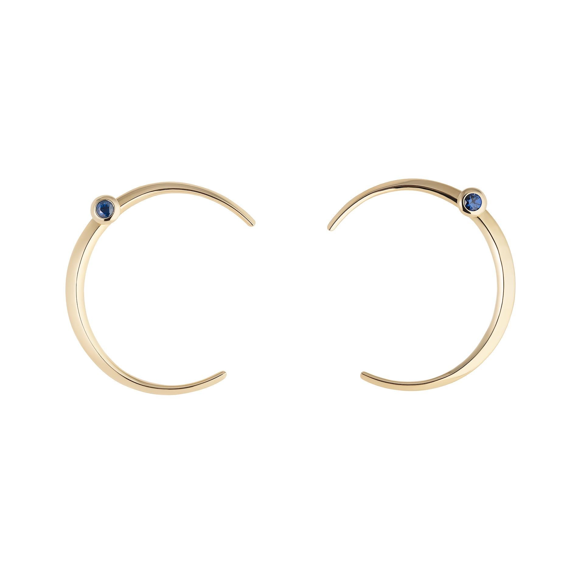 Towards the Stars Collection
These eye-catching moon earrings are perfect for those who love to make a bold statement. Crafted from lustrous yellow gold, their polished finish reflects the beauty of the night sky, while the deep blue sapphires add a