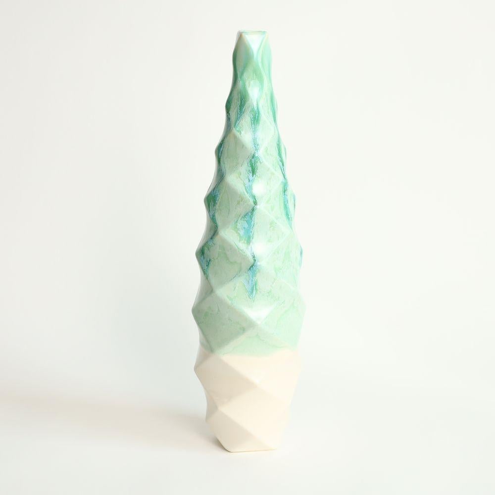Tower in Jade
The Tower is a stunning piece of contemporary art that exudes an air of sophistication and elegance. Its towering form, which rises up to an impressive height, commands attention and inspires awe.
One of the most striking features of