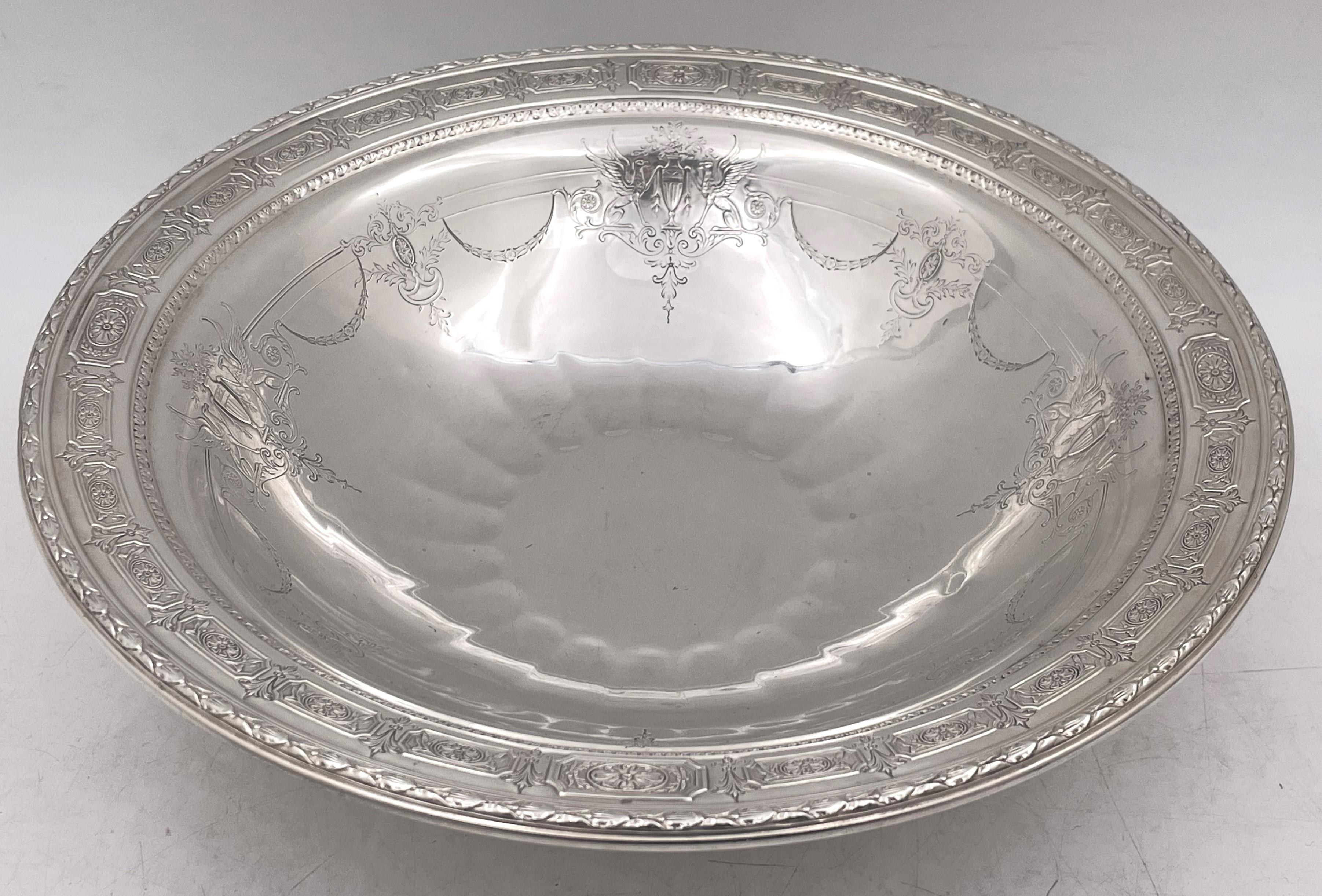 Towle pair of sterling silver centerpiece fruit bowls, beautifully adorned with floral and animals motifs in cartouches and among garlands and friezes. They measure 11'' in diameter by 3 3/8'' in height, weigh 35.2 troy ounces in total, and bear