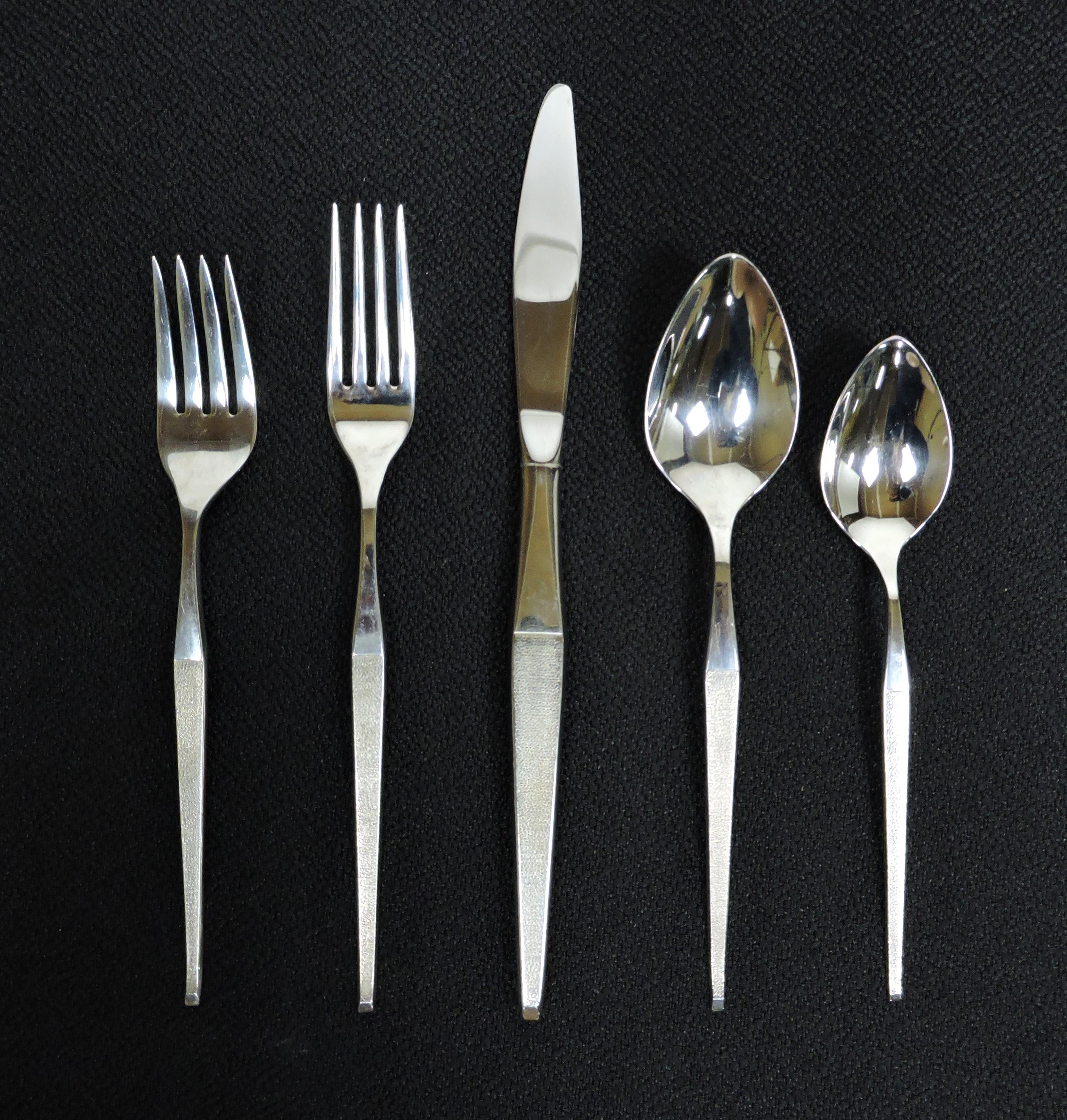 Sleek and modern 42 piece, service for eight, stainless steel flatware set in the Shape pattern manufactured by Towle. This high quality set is made of polished stainless steel with elegant tapered handles that are textured. Included are 8 forks, 8