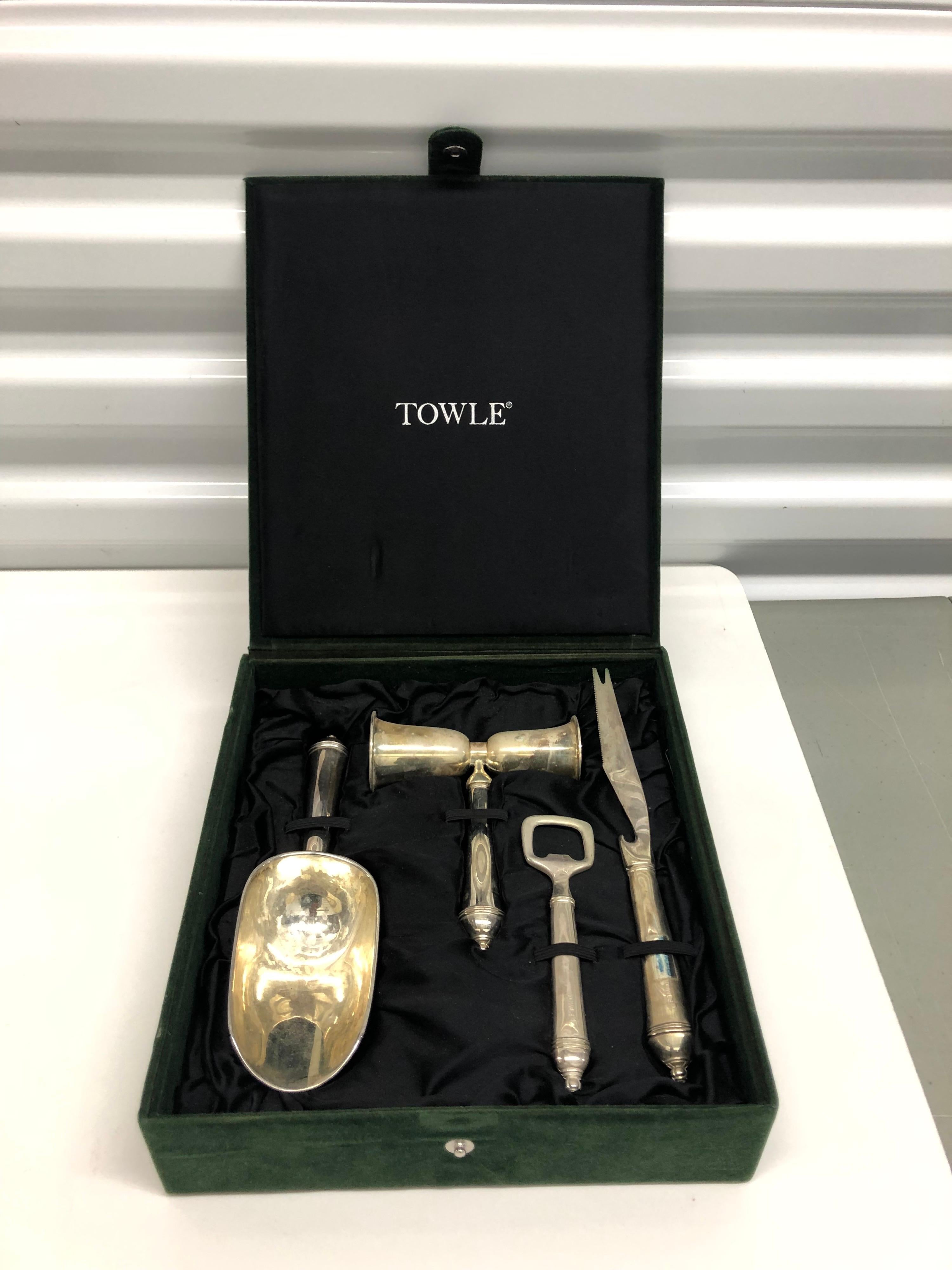 Towle silver plated bar set with case.
Comes with ice scoop, beverage jigger, bottle opener and garnish knife. 
Hunter green velveteen box size: 9