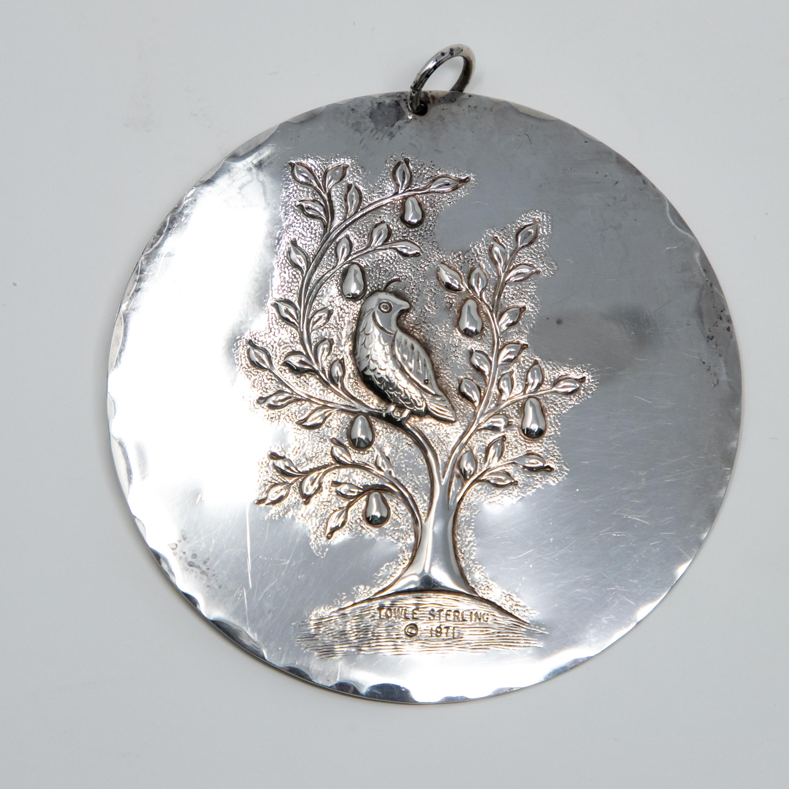 Offering this stunning Towle sterling ornament from 1971. Front depicts a partridge in a pear tree. Marked under the tree Towle sterling, 1971. The back depicts the dove of peace.