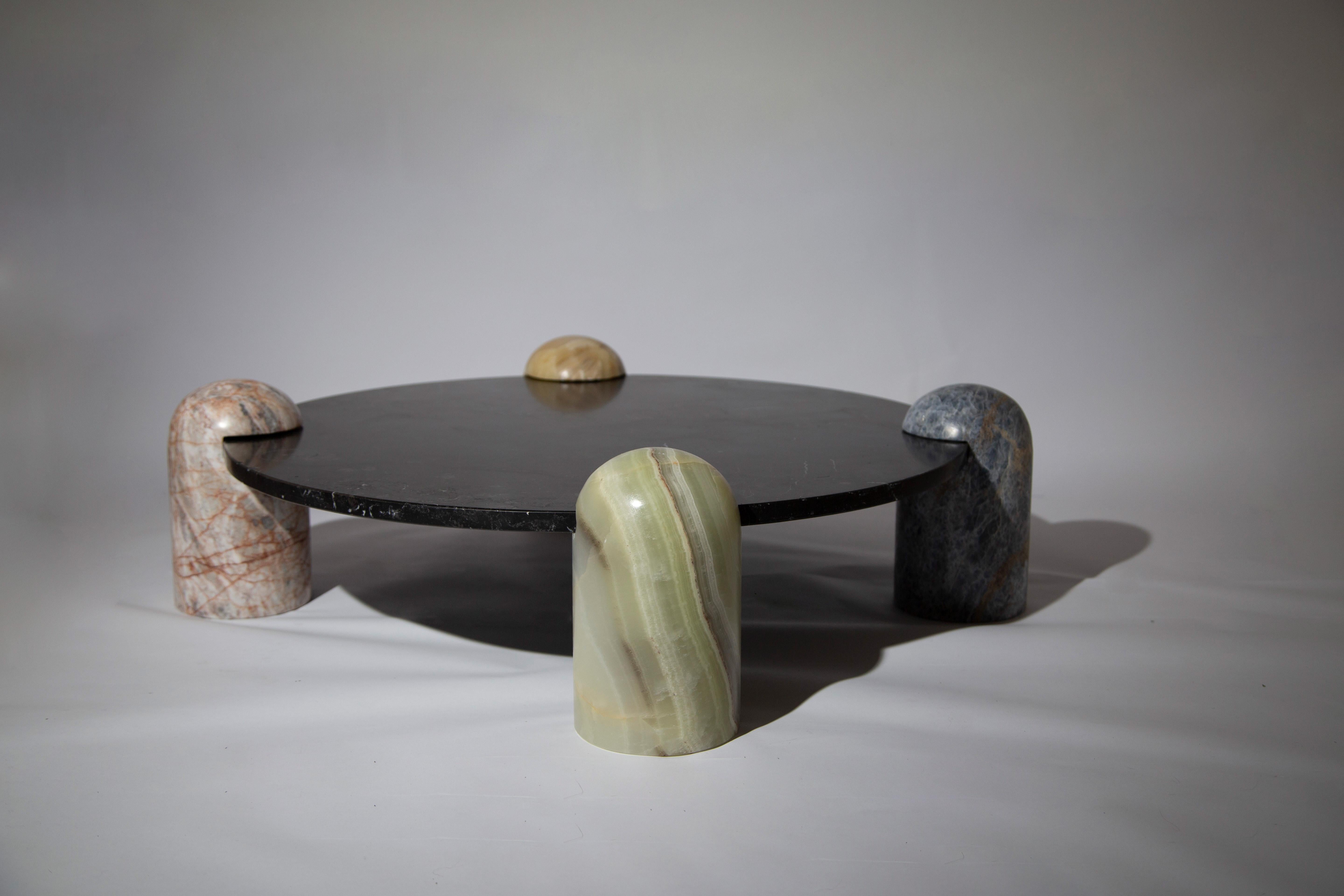 Toy Coffee Table by Panorammma
Dimensions: ⌀ 70 x H 40 cm
Materials: Blue Calacite, Pink and Black Monterrey Marble, Caramel and Green Onyx


Rounded pillars of blue calcite, pink marble, caramel onyx and green onyx carry a black marble top to