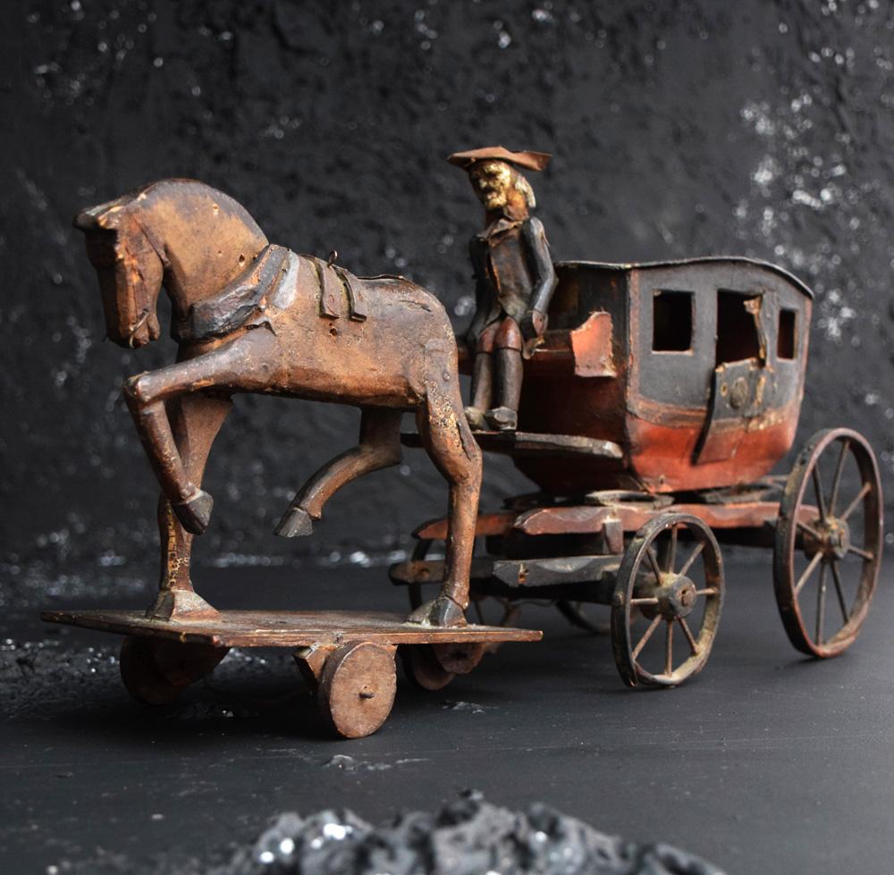 Item: 19th century toy horse and carriage

This lot is a very rare survivor of the mid-19th century in the form of the “The Highway Man” Toy horse and carriage. A wonderful example of Folk Art craftsmanship, this item is without doubt a museum