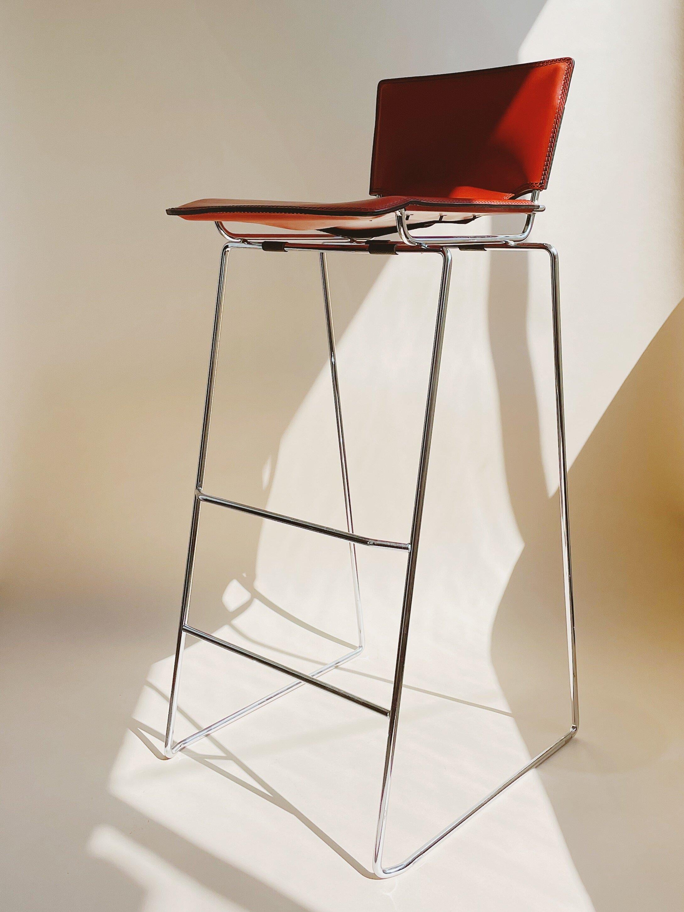 Toyoda Hiroyuki for ICF Group c. 1980

Set of three vermilion red leather stools designed by Toyoda Hiroyki for ICF Group. Saddle stitched Italian leather on a chrome frame with a lace up back. Stools stack for easy storage.

Measures 34.5” tall