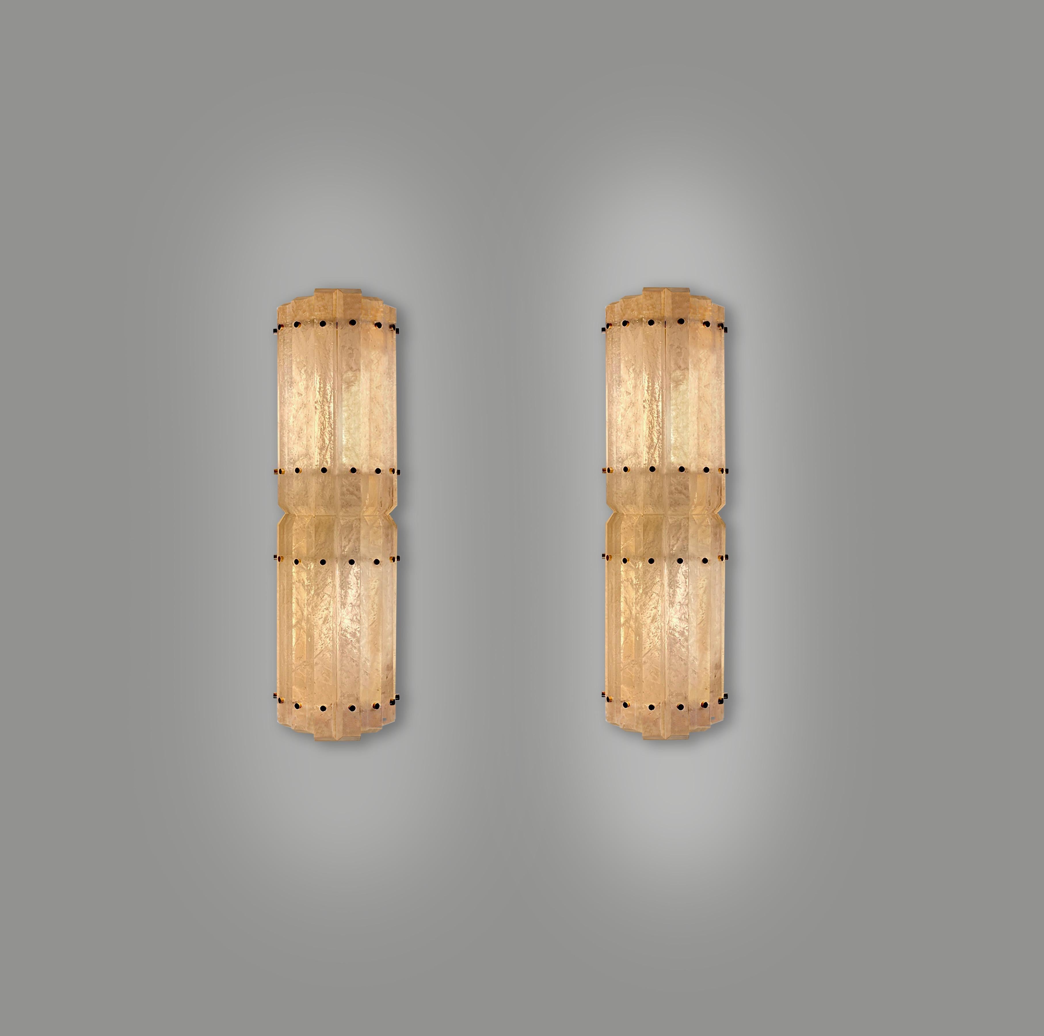 Pair of modern rock crystal sconces with aged brass decorations,Created by Phoenix Gallery.
Two sockets installed. Use two long tube style LED light bulbs, 160w total.