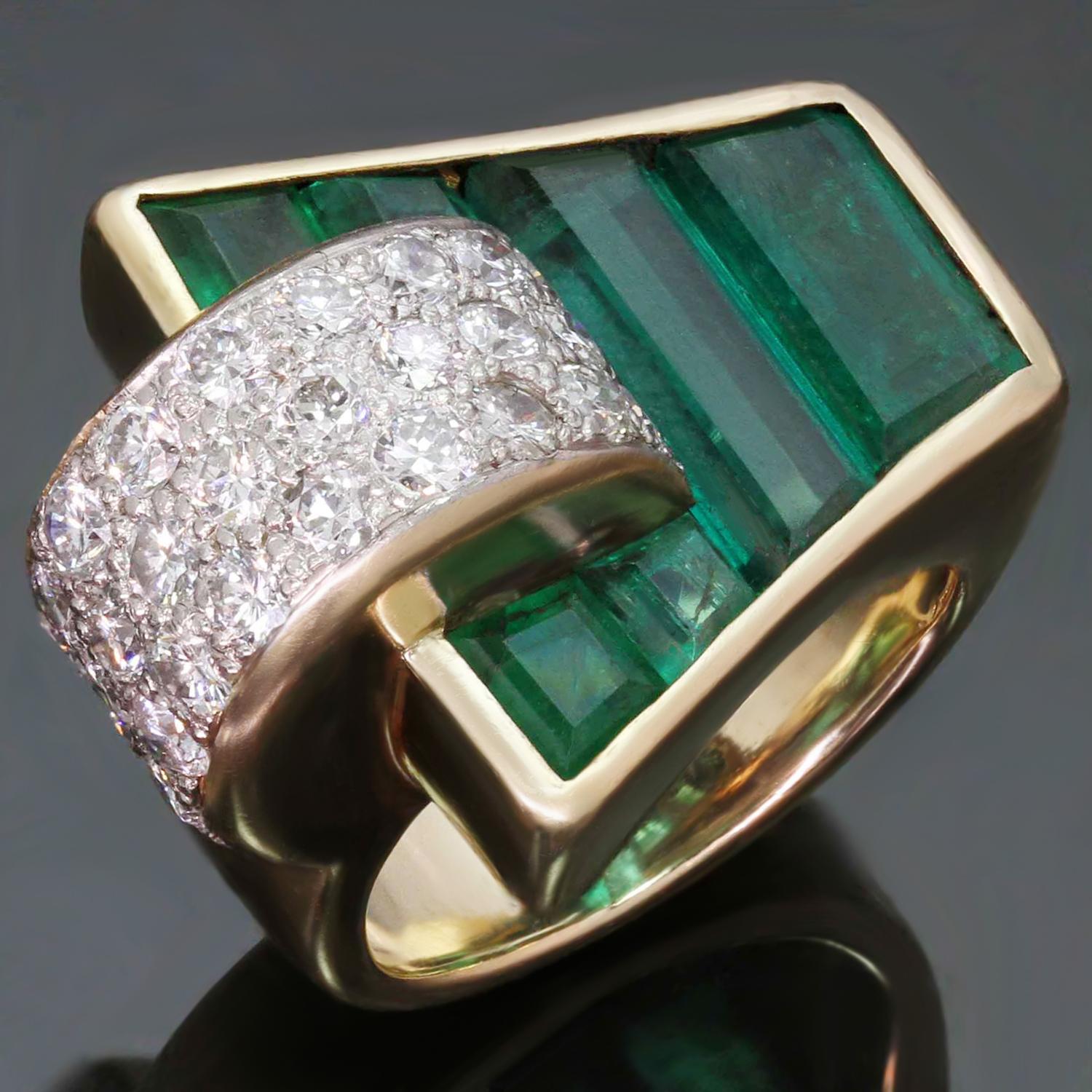 This rare and gorgeous antique Trabert & Hoeffer Mauboussin ring is crafted in 14k yellow gold and set with Colombian emeralds measuring an estimated 18mm x 23mm and weighing an estimated 3.0-3.50 carats and 30 pave-set diamonds weighing an