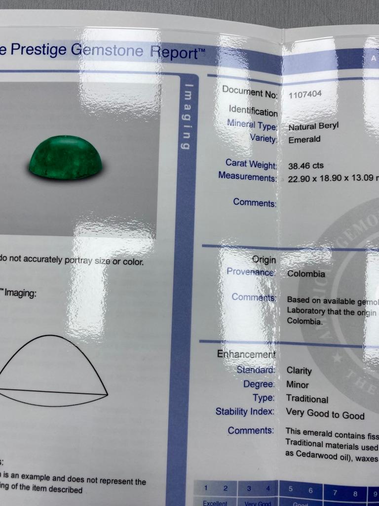 Centering very fine oval cabochon Colombian emerald ap. 38.46 cts., flanked by 14 rounded shoulders of 14 round diamonds ap. .65 ct., signed T & H M, no. 2533, circa 1940, ap. 11.3 dwts. Size 7 1/2.

With AGL report no. 1107404 stating Colombian