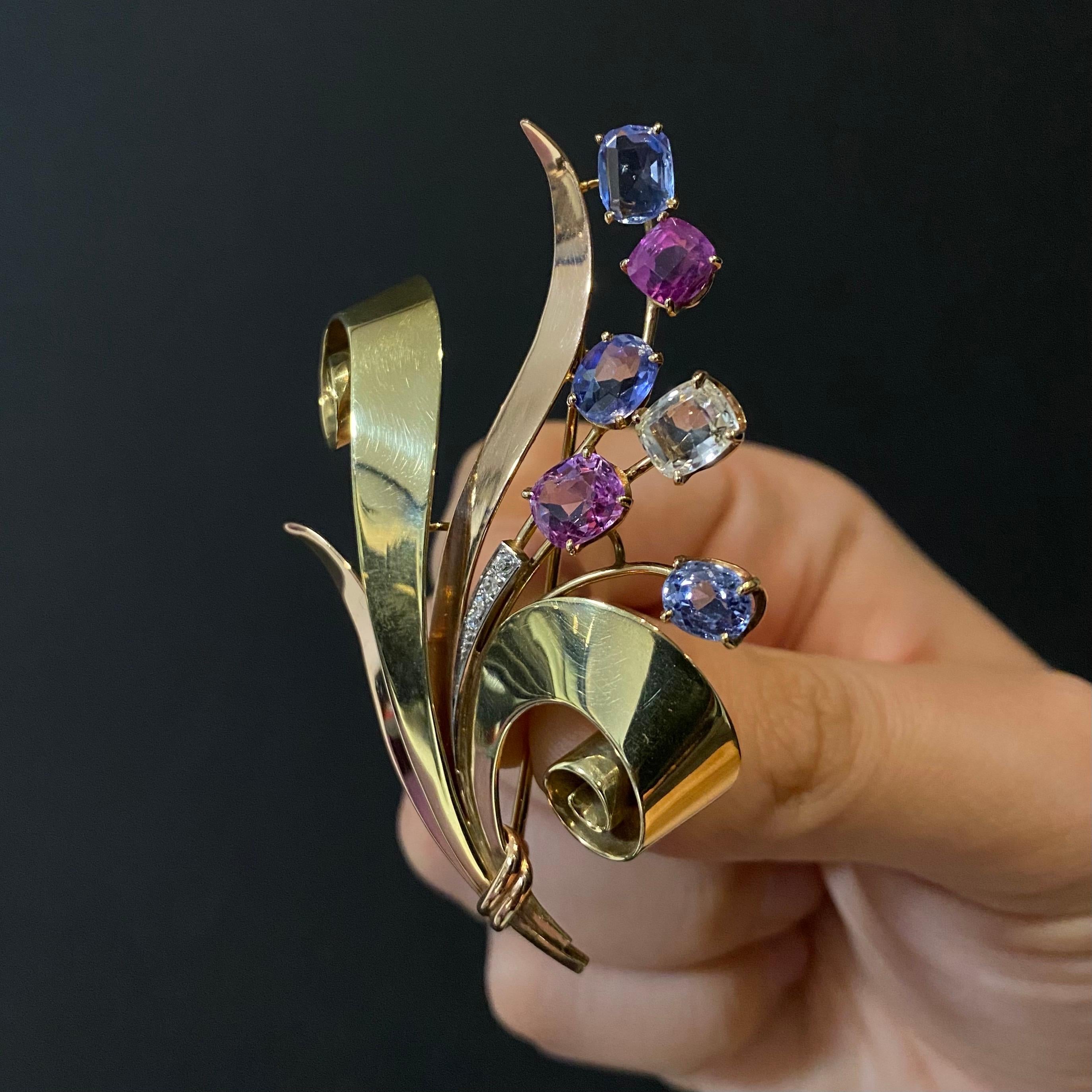 One-of-a-kind Retro Trabert & Hoeffer Mauboussin Reflection 7.60ct Sapphire, Ruby and Diamond Floral Bouquet Brooch in 14K Yellow, Pink and White Gold, 1940s. This vintage brooch is designed as a stylized floral bouquet featuring five natural