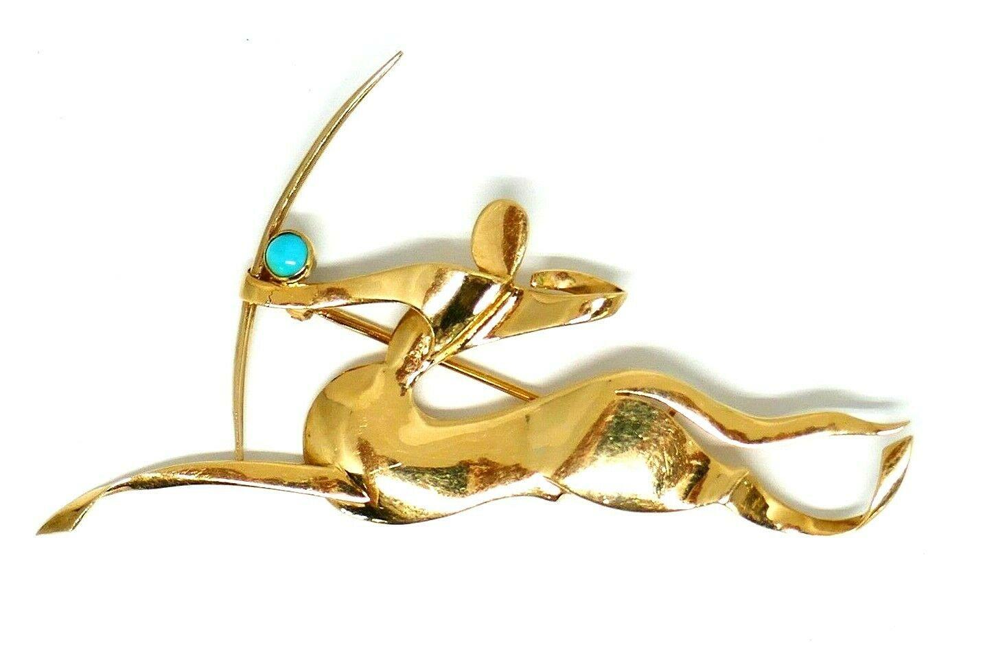 Vintage (c.1970) astrological piece by Trabert & Hoeffer Mauboussin, 14k yellow gold Sagittarius brooch with a turquoise accent. 
Stamped with the Trabert & Hoeffer Mauboussin maker's mark and a hallmark for 14k gold. Engraved 