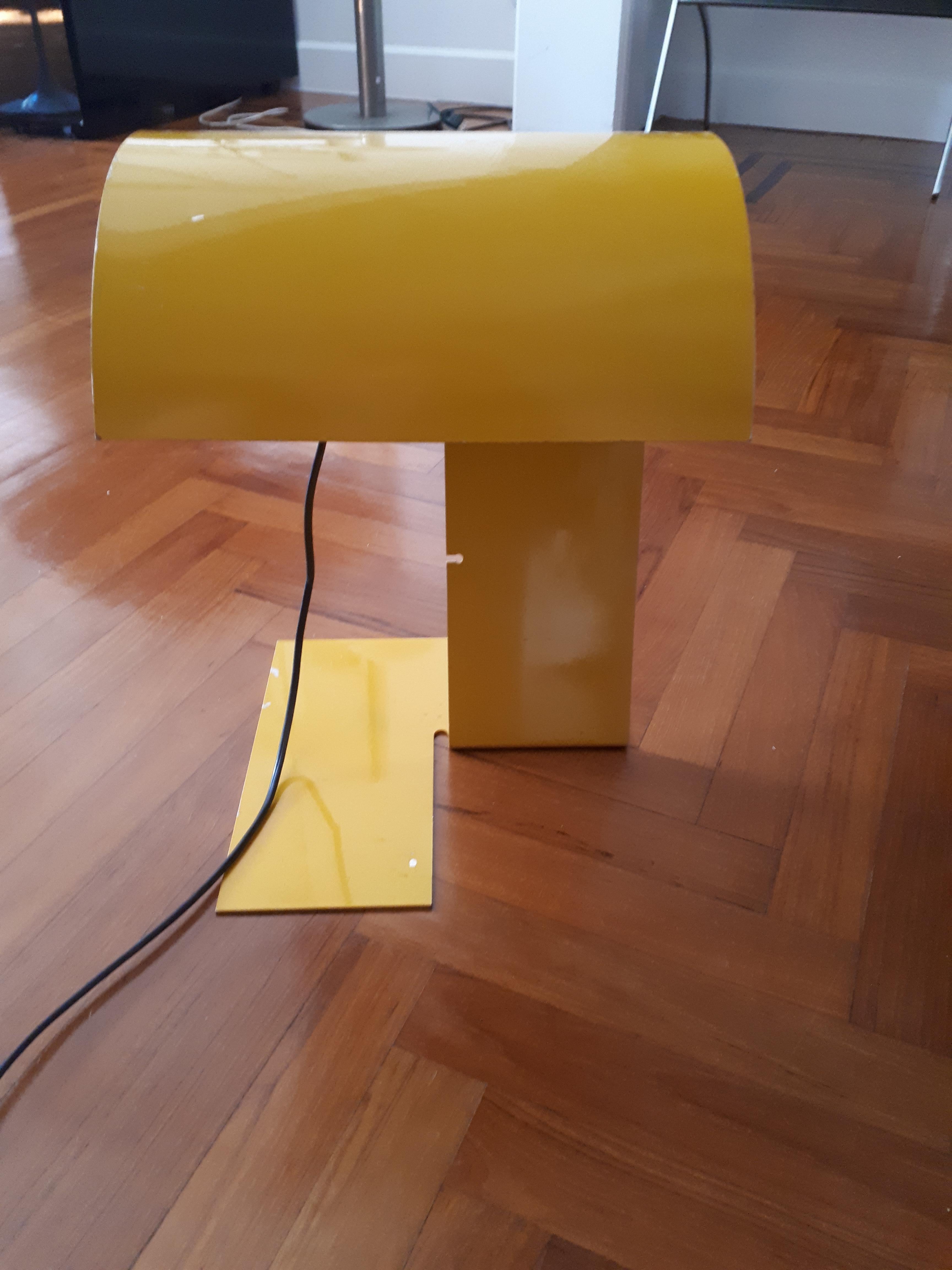Table lamp model Blitz designed by Trabucco, Vecchi and Volpi for Stilnovo (1973). 
This lamp was made by shaped metal sheet and lacquered in yellow color.
Brand Stilnovo engraved on the base.
     
