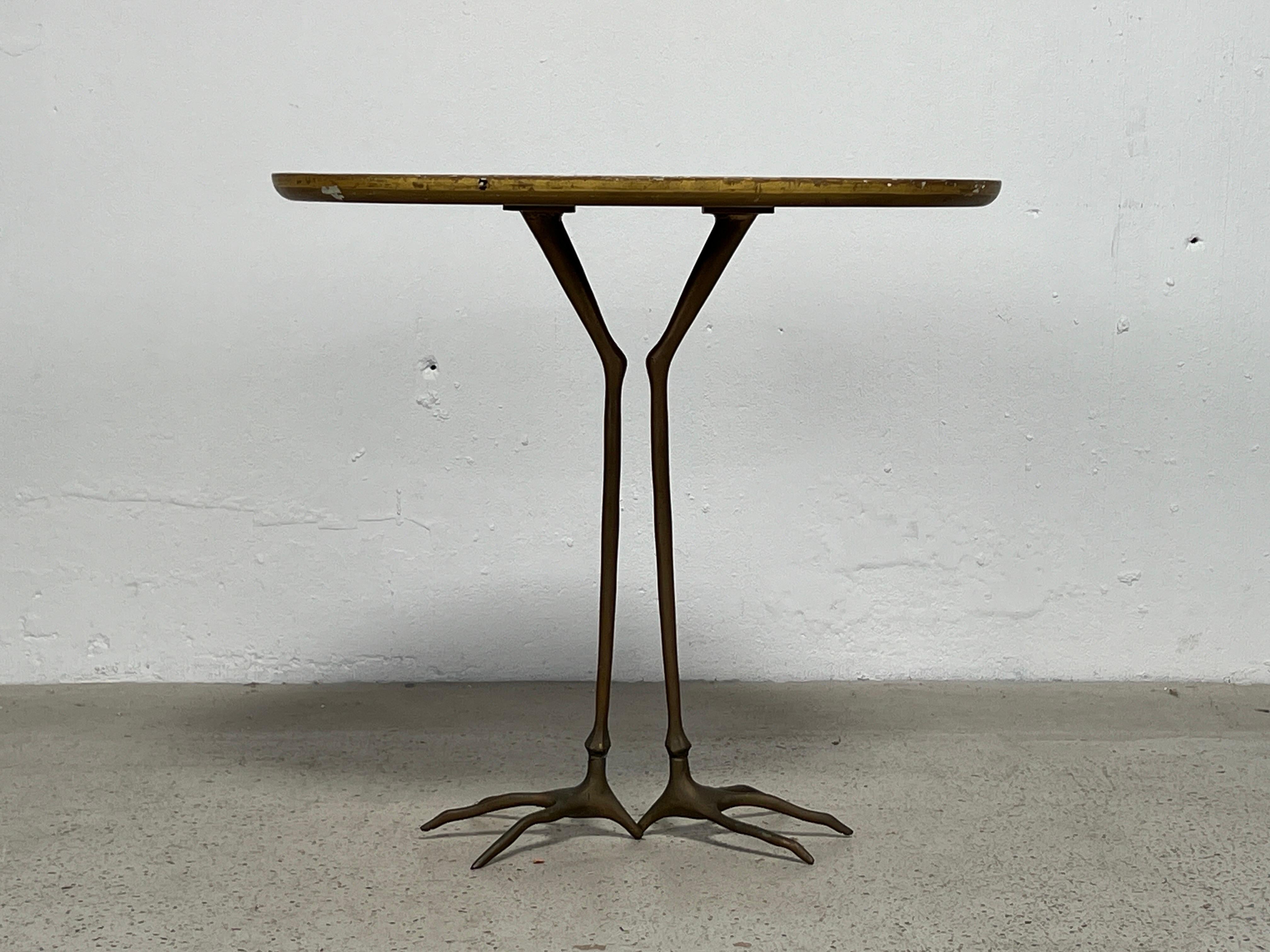 The 'Traccia' table with gold leaf top and brass legs. Designed by Meret Oppenheim and produced by Simon International, 1972.