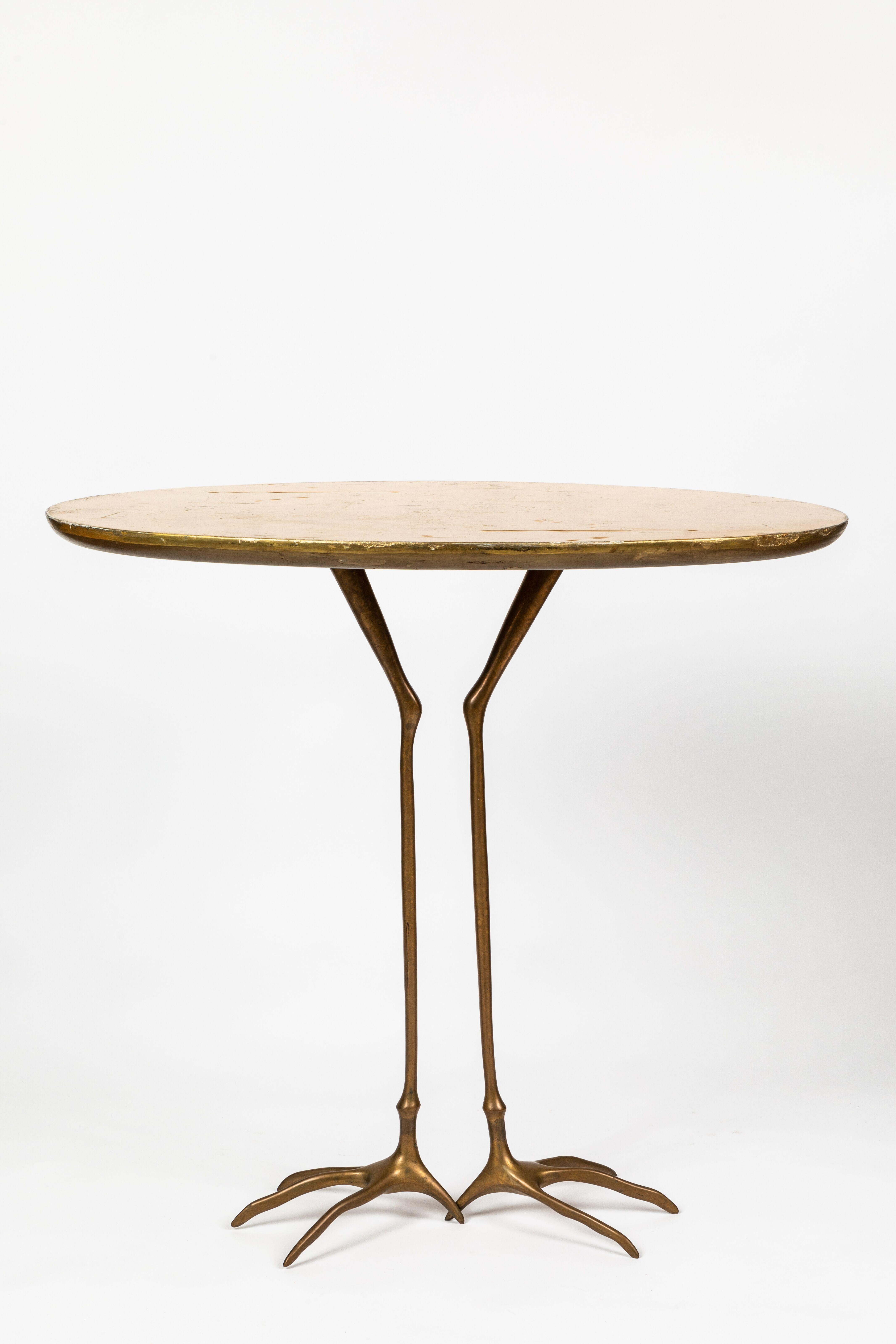 Meret Oppenheim 'Traccia' table, Italy, Circa 1972.
Méret Oppenheim for Cassina.
Bronze base with oval gold leaf and wood top.
Bird foot imprints on the top.
Measures: 26.5