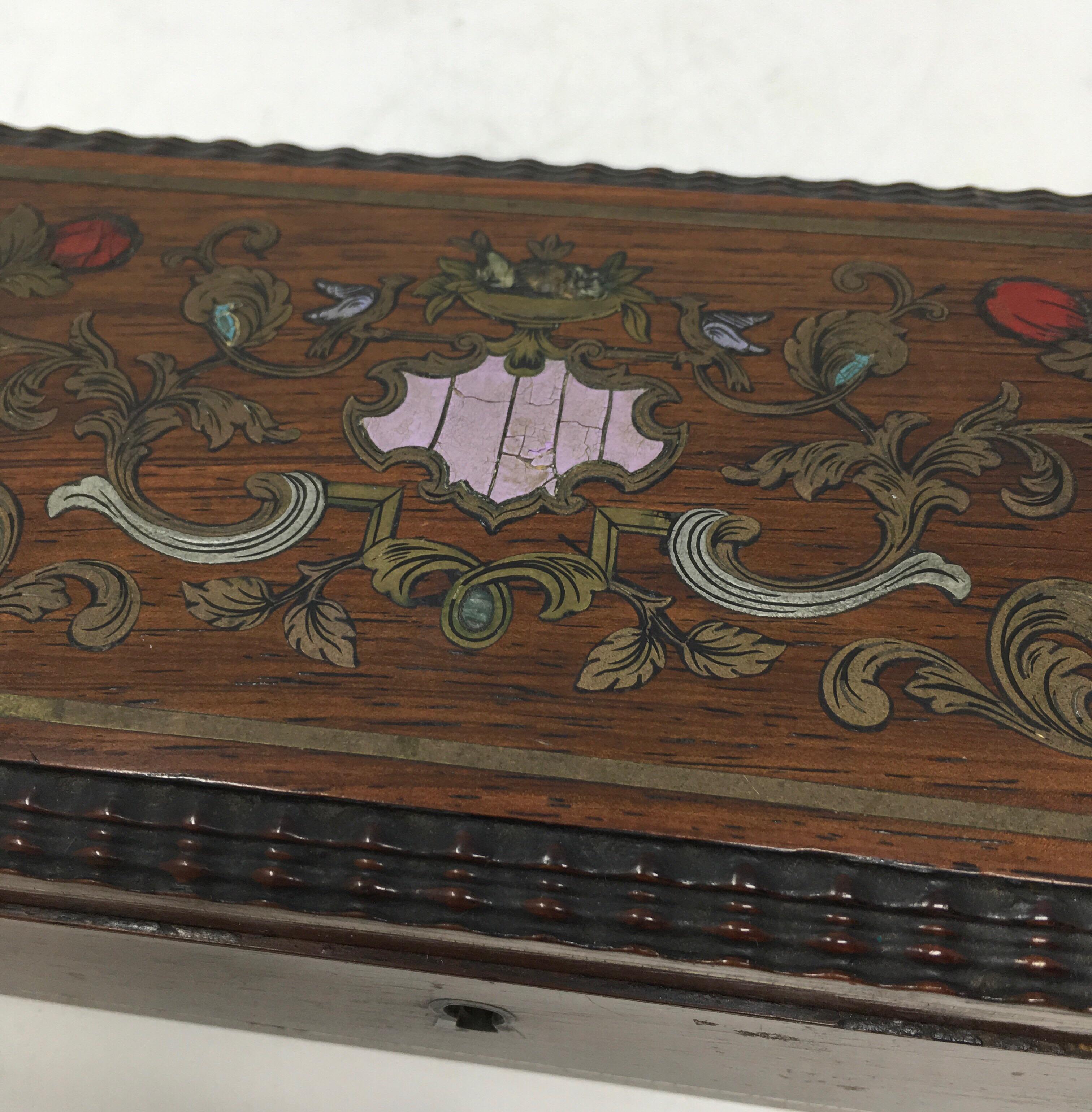 Decorative inlay wooden box. The box is lined with a blue satin material. No further markings.
