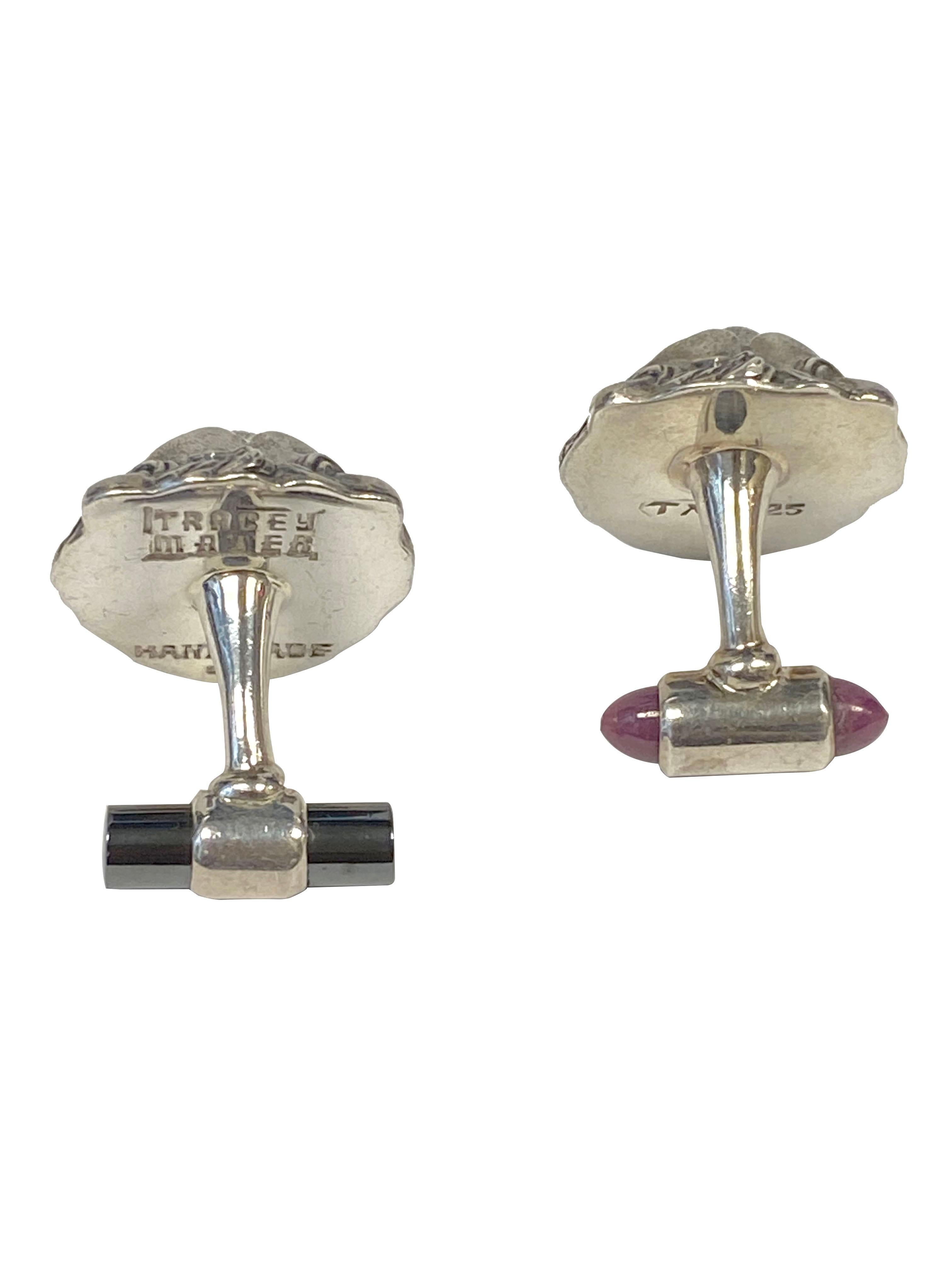 Circa 2018 Sterling Silver Cufflinks by famed Chicago Designer Tracey Mayer, these solid very detailed links measure 1 X 7/8 inch and have Ruby Eyes and Cab Ruby end pieces. 