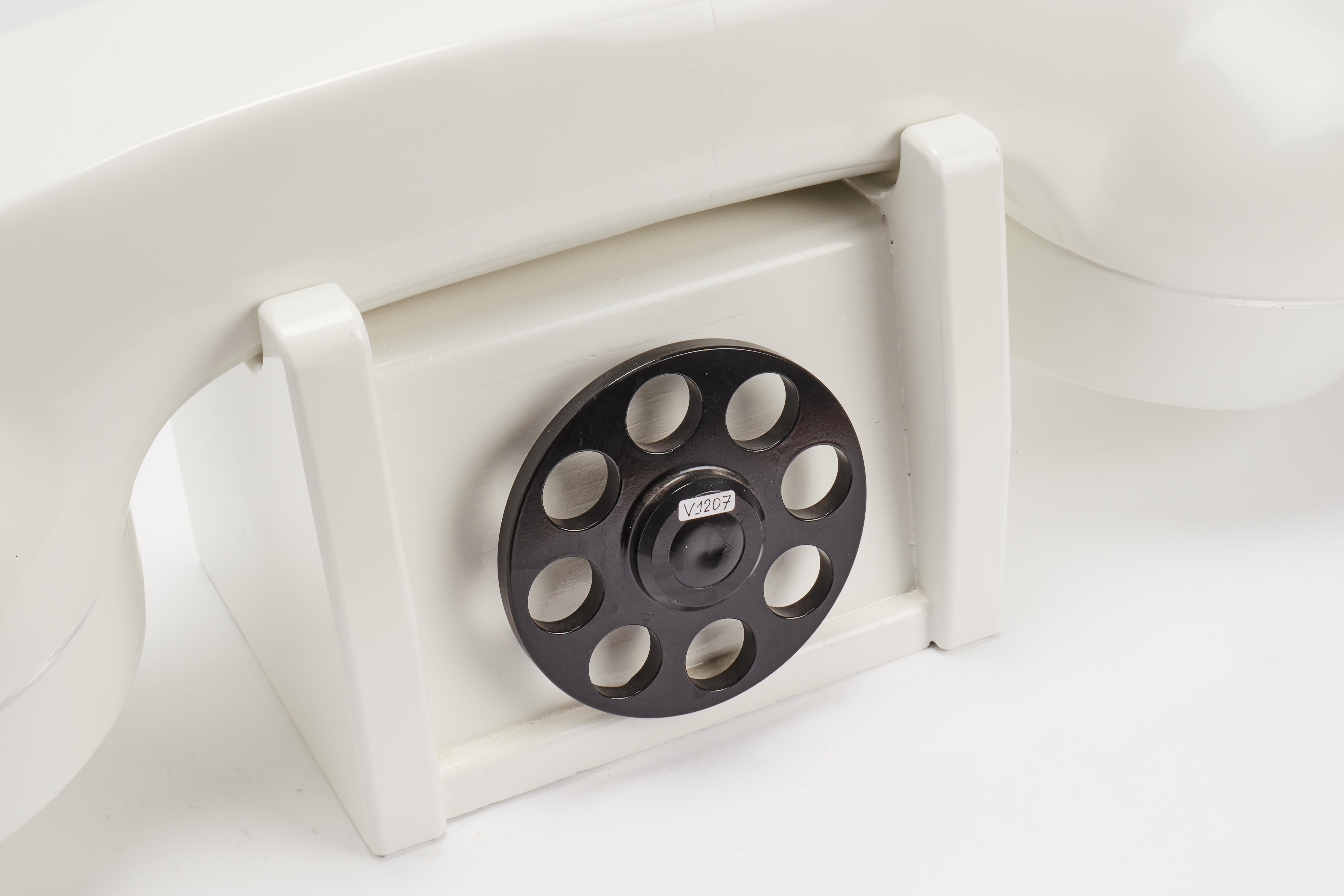 A window trade sign of an american telephone company, depicting a big phone. Carved out of fruit wood, and white enamel painted. United States of America half 20th century.