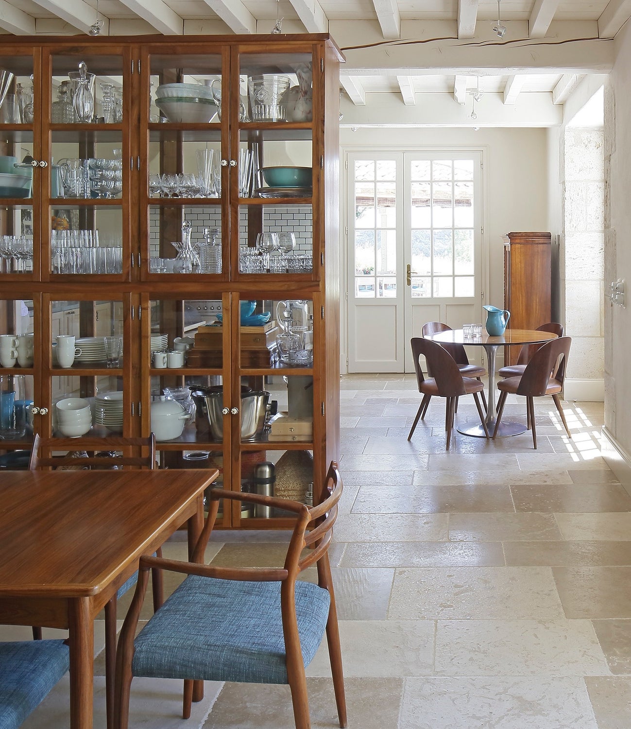 A large double-sided glass cabinet for storage by McQuin ...