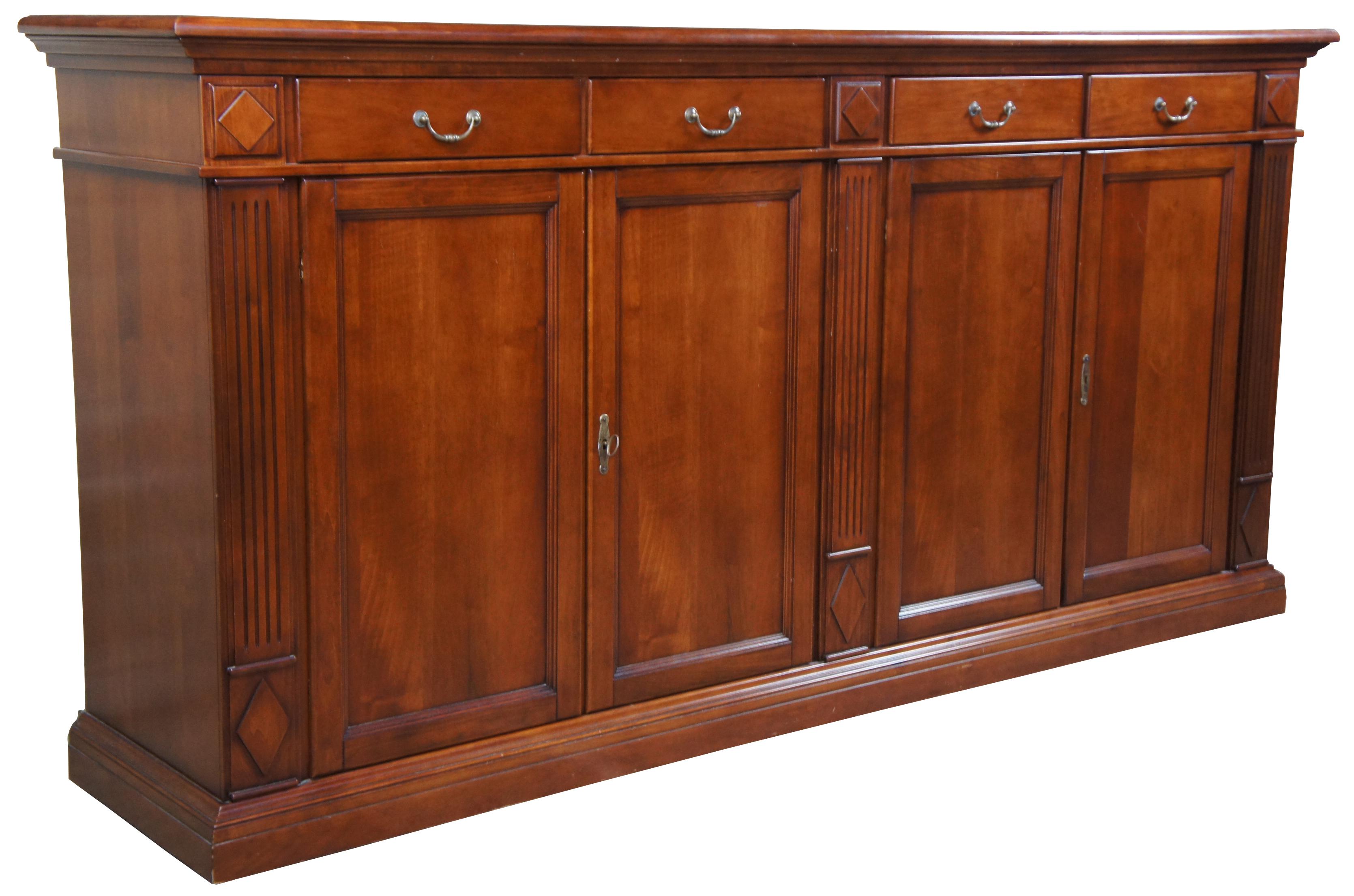 Italian made and traditional inspired cherry sideboard. Features a tall stature with four drawers over lower cabinets. Includes fluted columns between diamond pattern medallions. Could be used as a bookcase, bar back, media cabinet or entry, hallway