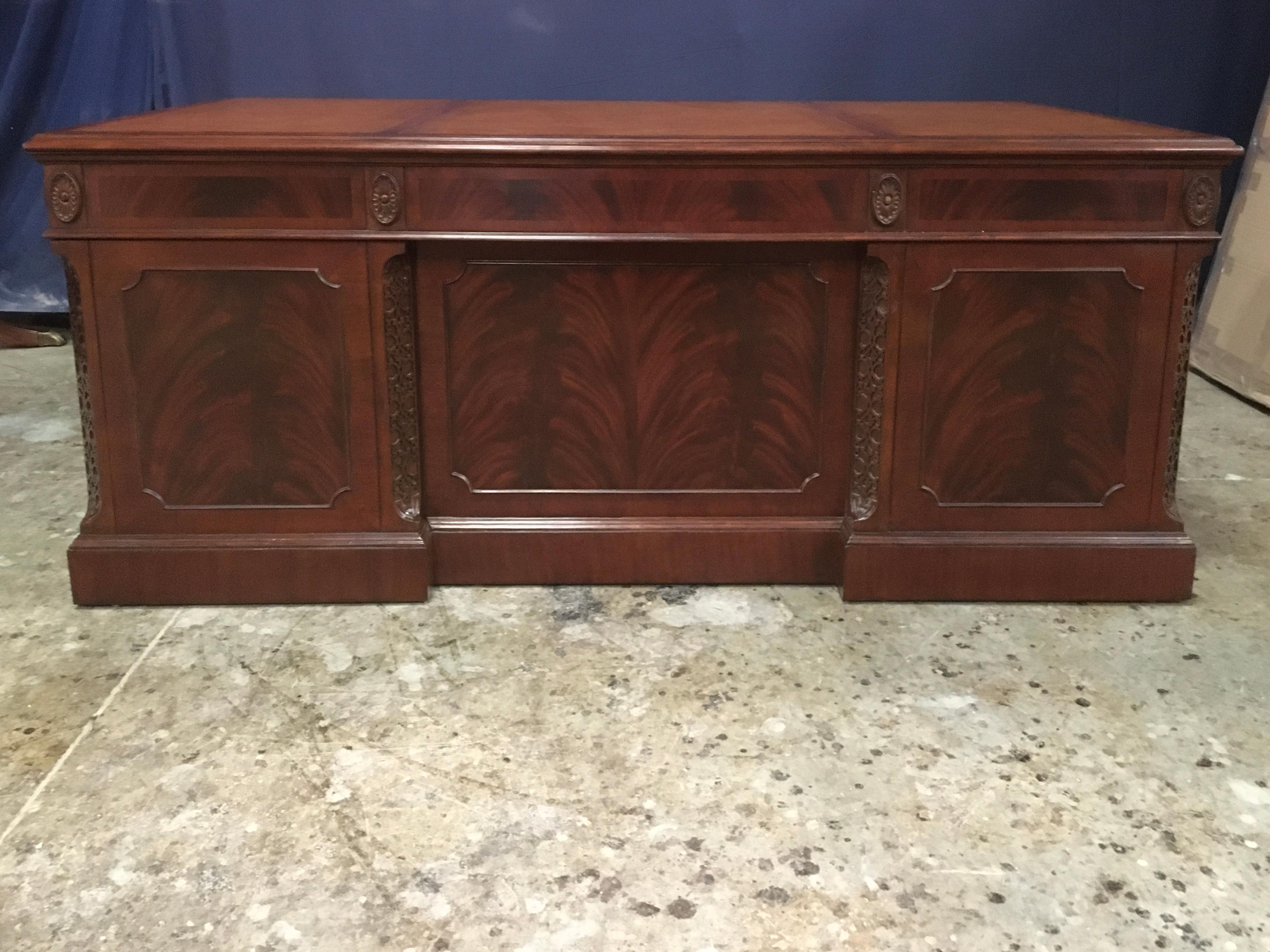 This is a new traditional mahogany executive desk. Its design was inspired by large desks from the 1800s. It is the regular size version of our classic (84”) LH-3084. It features a top of brown leather with gold tooling. Its front and side panels