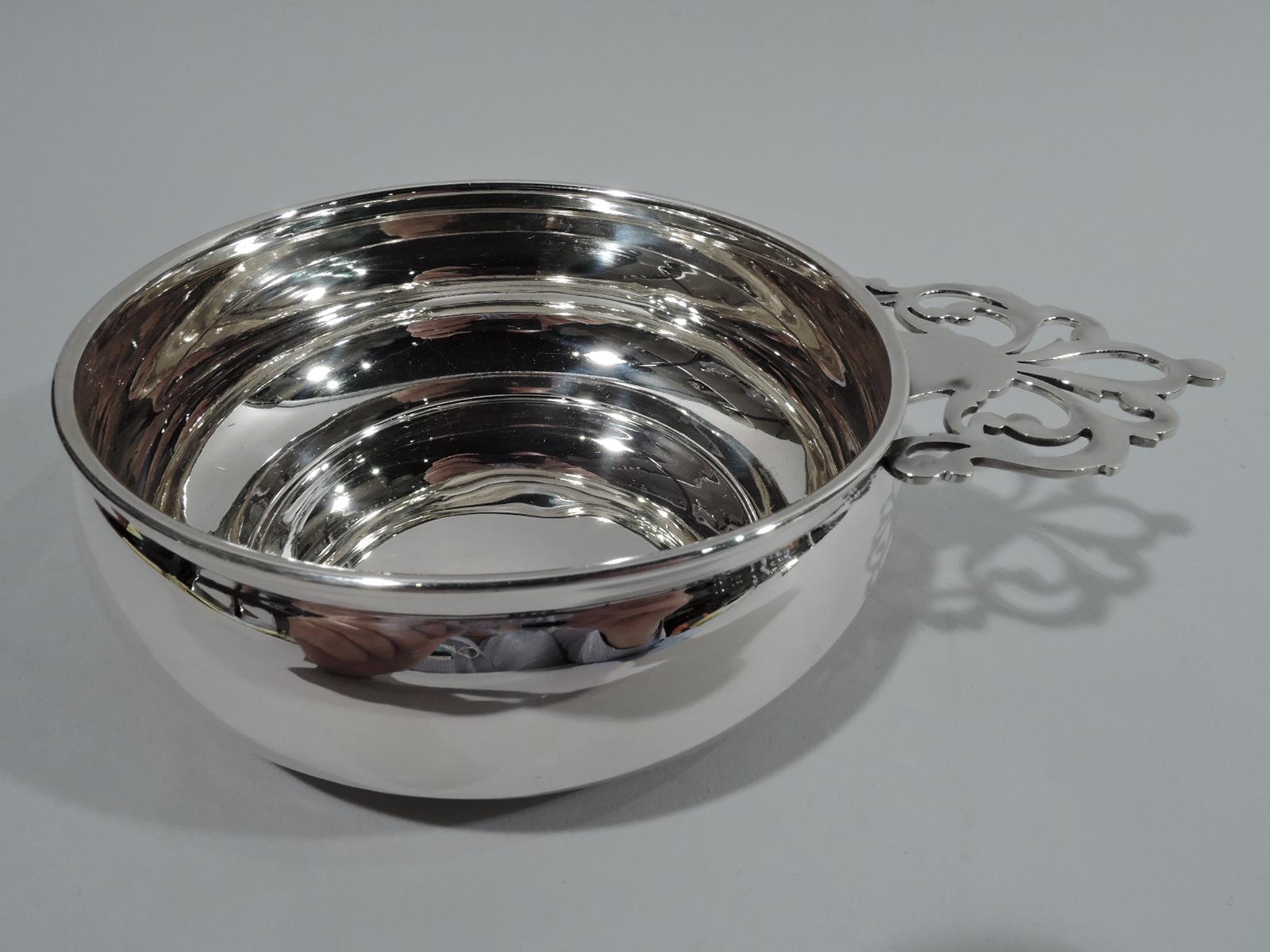 Traditional American sterling silver porringer. Round and curved bowl and open scrolled handle. Plenty of room for engraving. Marked “Sterling / 560”. Weight: 3 troy ounces.