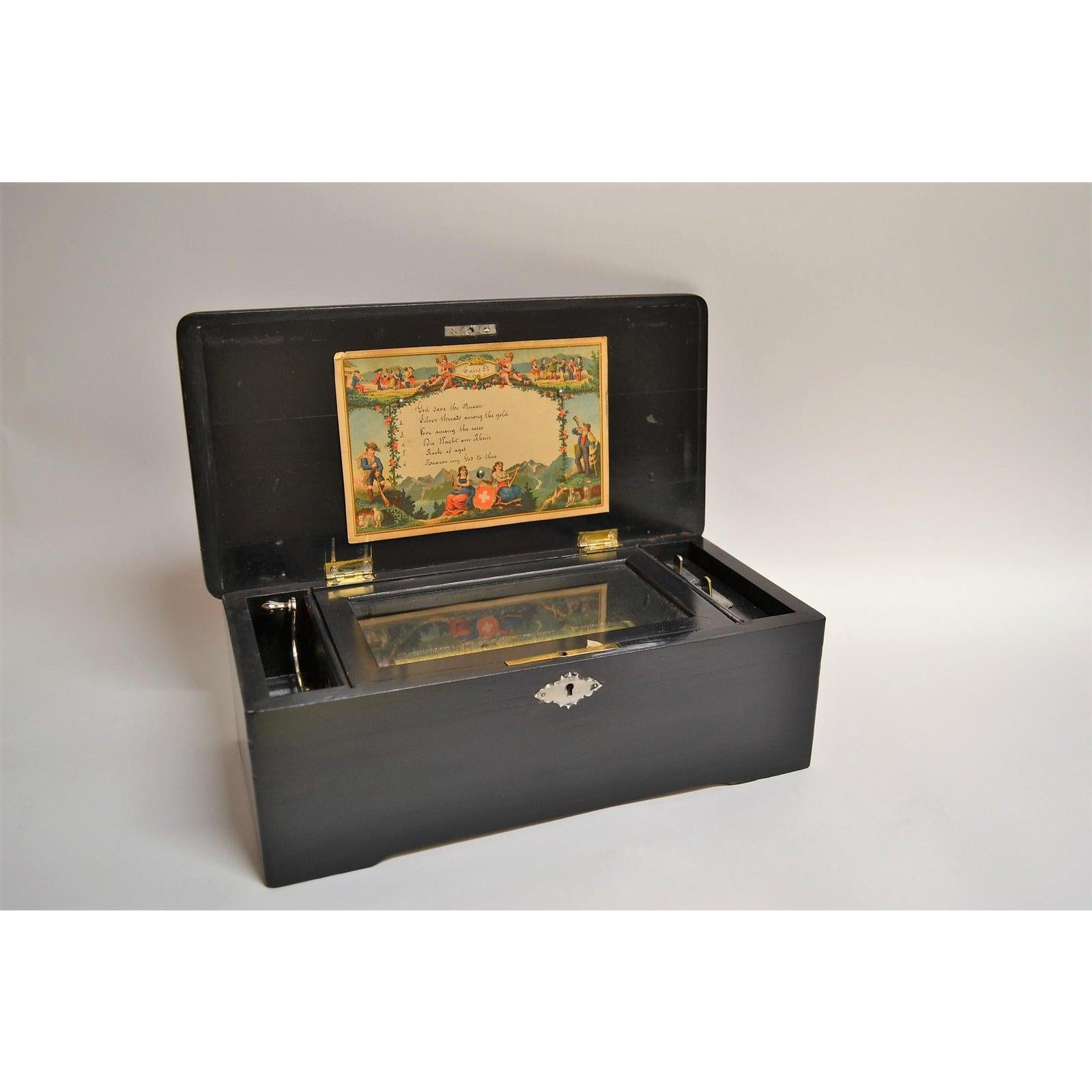 An enchanting music box in fine working order. Traditional antique 19th century music box with inlaid case.
 