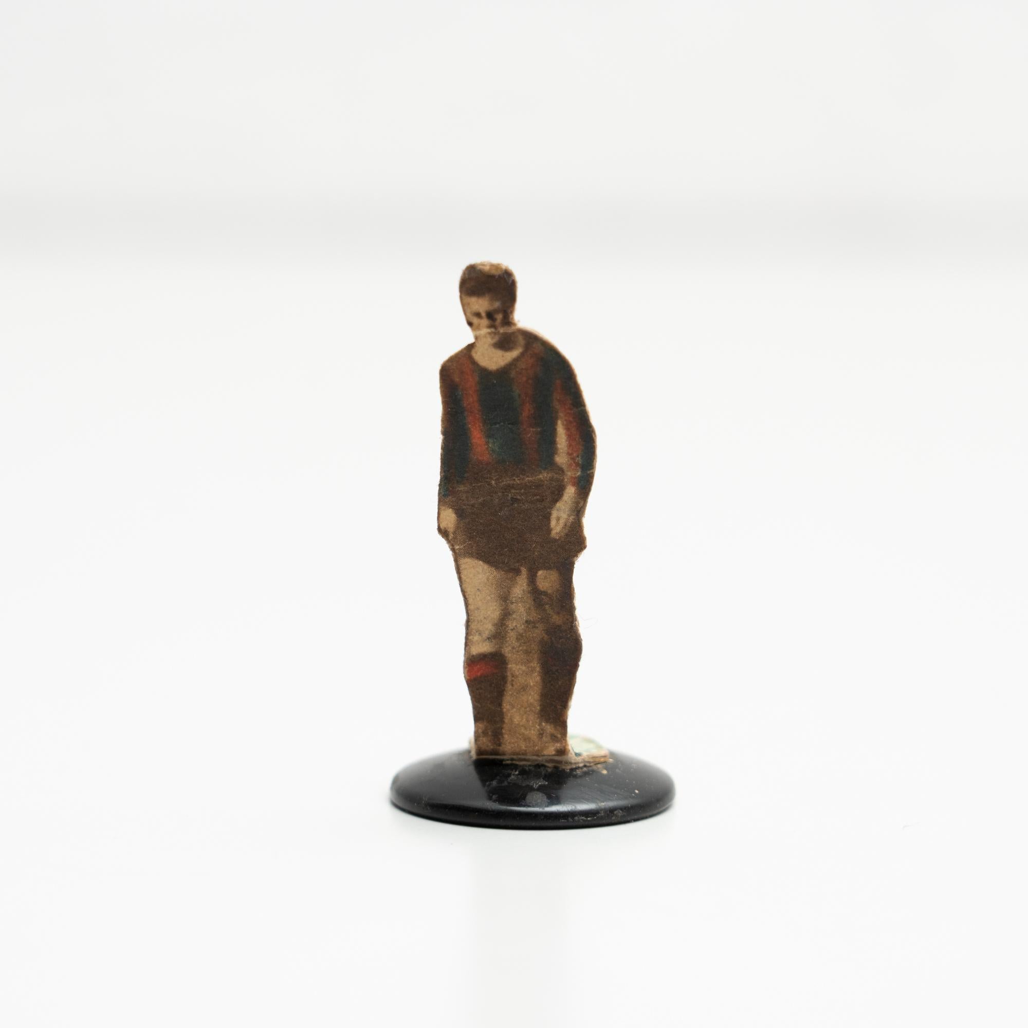 Table button soccer game player. Traditional figure used to play this classic button Spanish game. The figure is usually made by attaching a football player photograph, or sometimes a drawing, attached to a clothing button.    Manufactured in Spain,