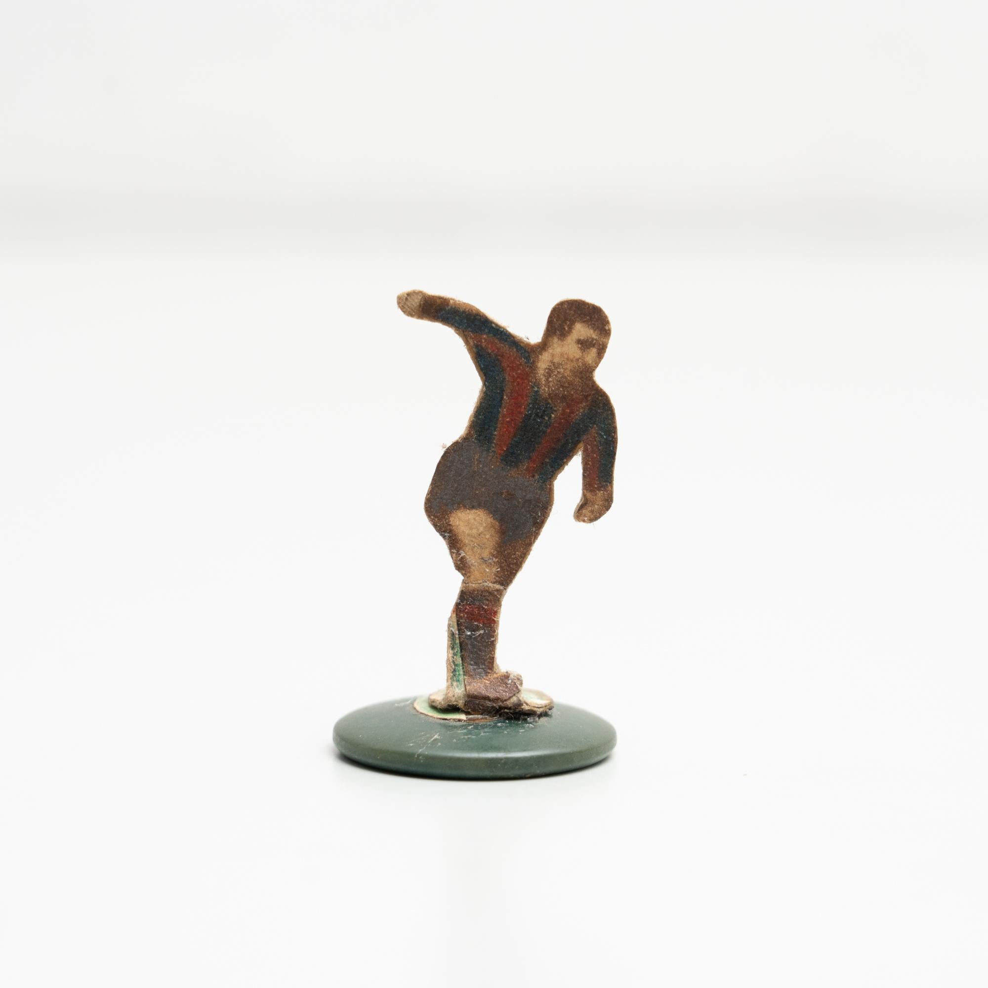 Table button soccer game player. Traditional figure used to play this classic button Spanish game. The figure is usually made by attaching a football player photograph, or sometimes a drawing, attached to a clothing button.

Manufactured in Spain,