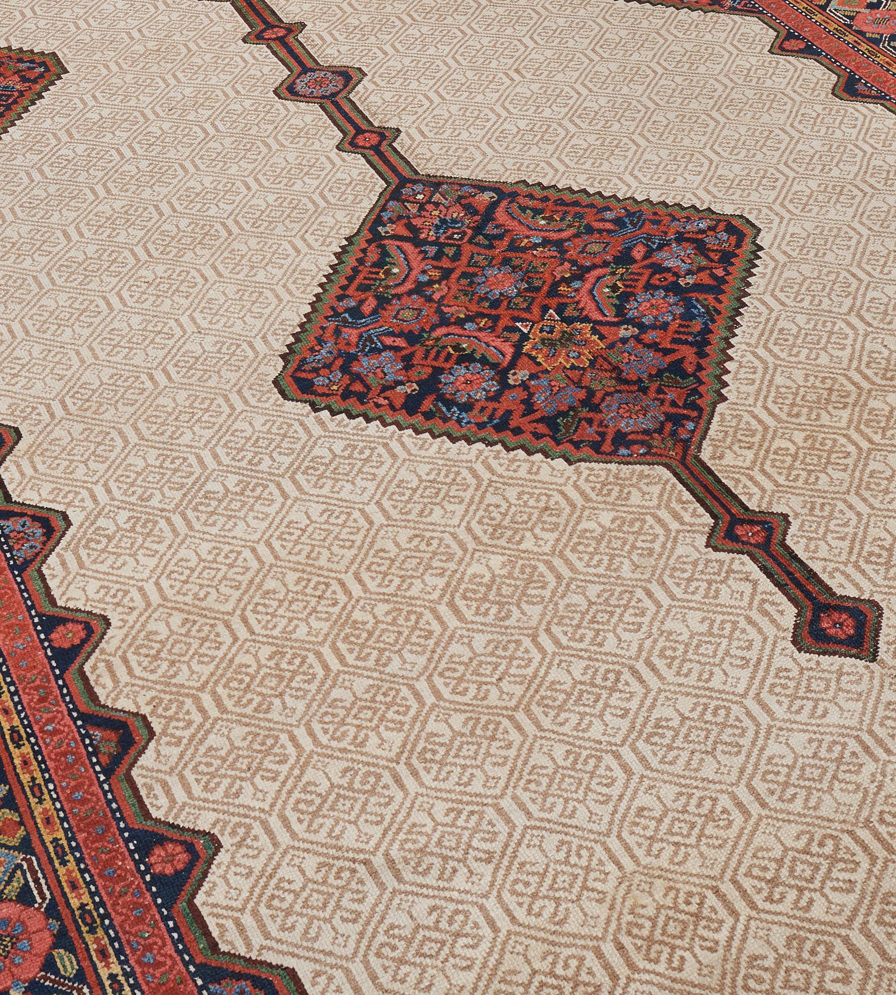 This antique, circa 1900, Persian Serab Runner has an ivory field with a soft buff-brown honeycomb design containing a central hooked floral motif around a central column of linked indigo-blue serrated lozenges containing a polychrome