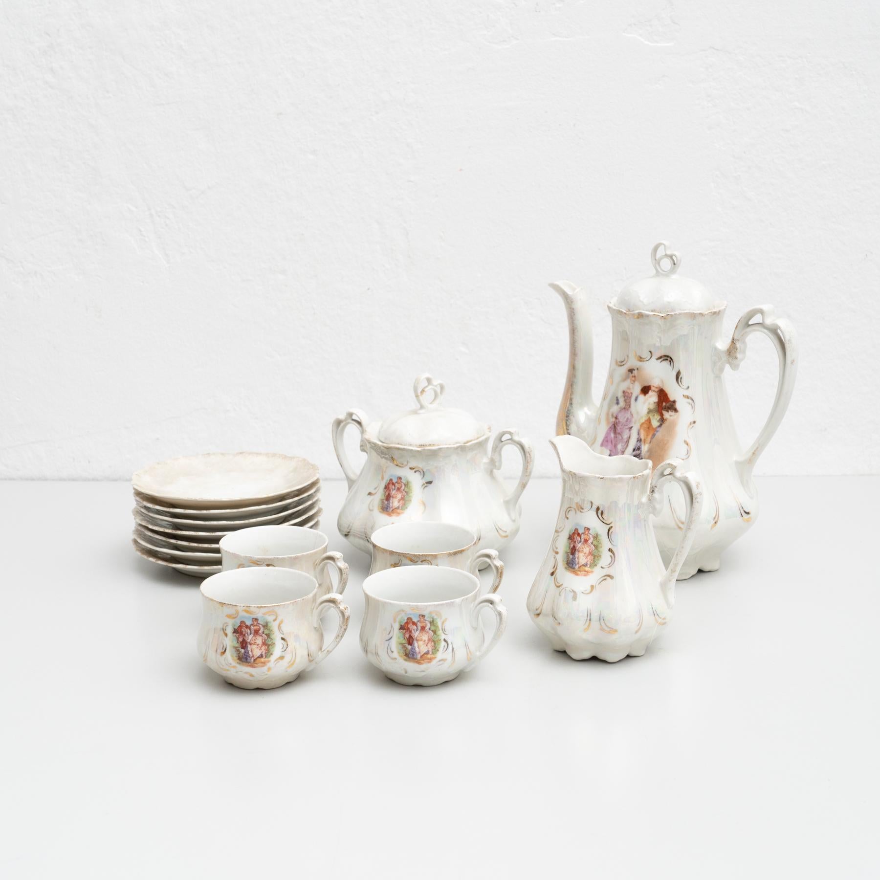 Antique tea set consistent of 14 pieces including coffee plates, coffee cups and pots. 

Hand painted in the traditional French style.

Made by an unknown manufacturer in France.

In original condition, with minor wear consistent of age and