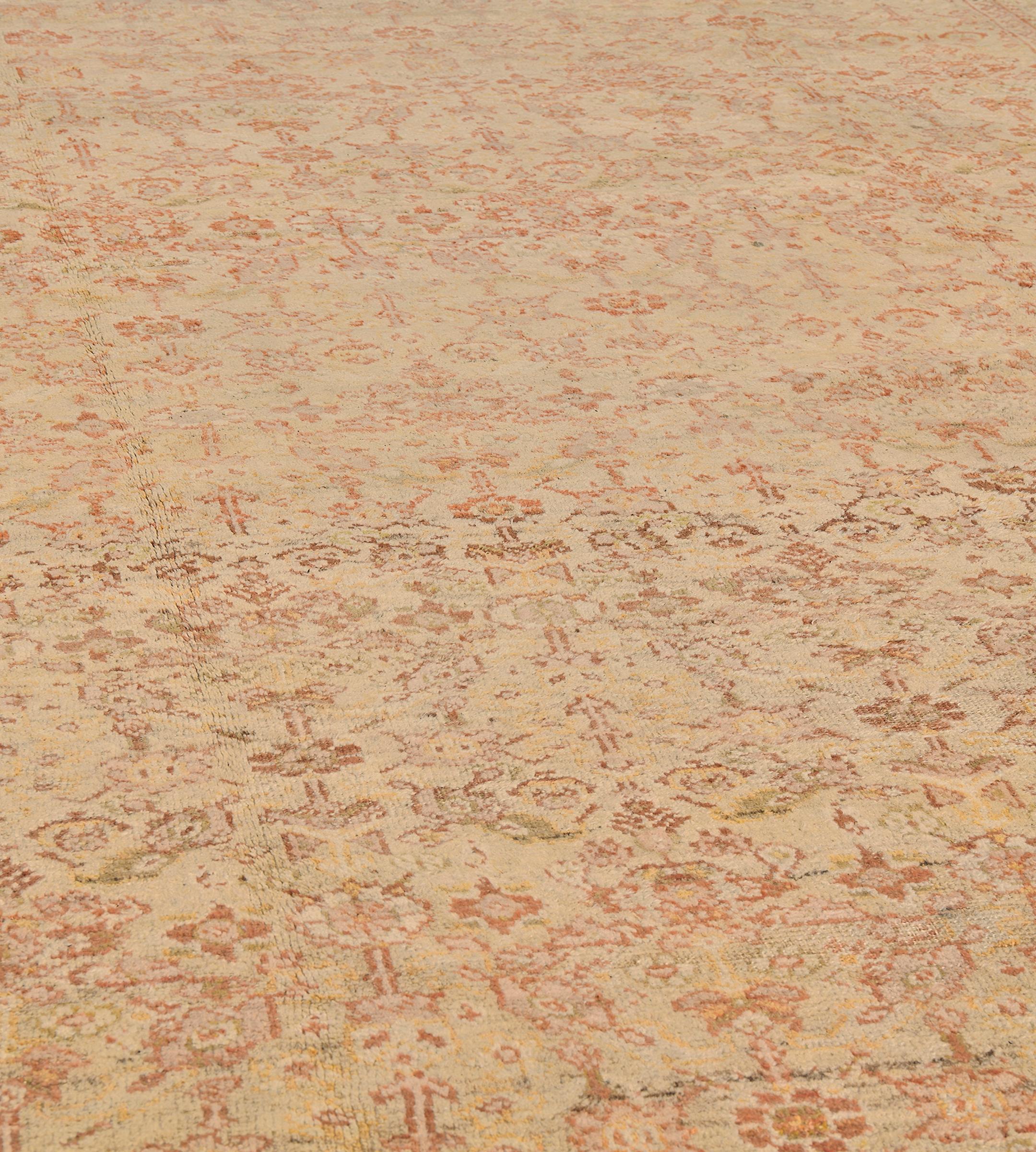 This traditional hand-woven Persian Ziegler Sultanabad rug has a shaded rustic beige field with overall tonal floral lattice, between complementary meandering floral stripes.