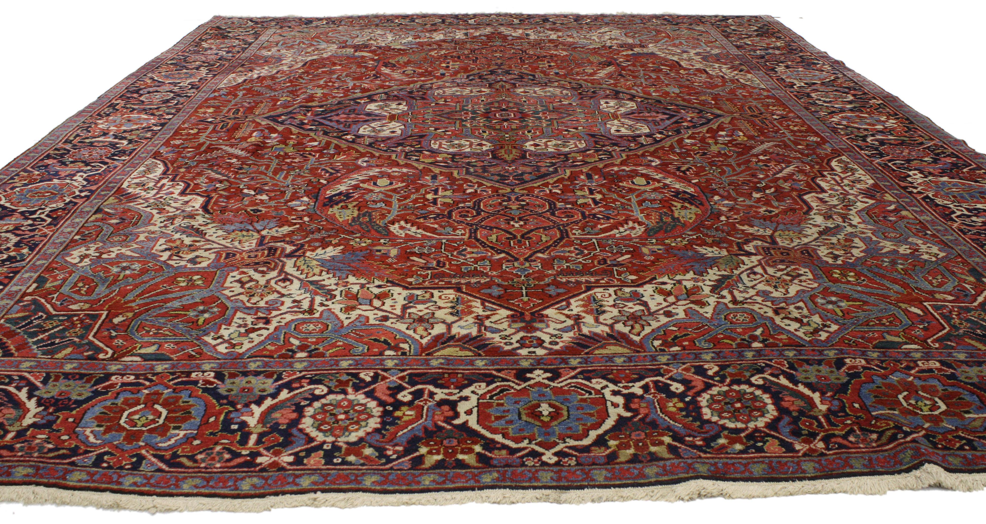 77040, traditional antique Persian Heriz rug with English country style manor house. Traditional and regal with brilliant color, this antique Persian Heriz Area rug features a cusped octofoil medallion set with multiple lobed medallions within an