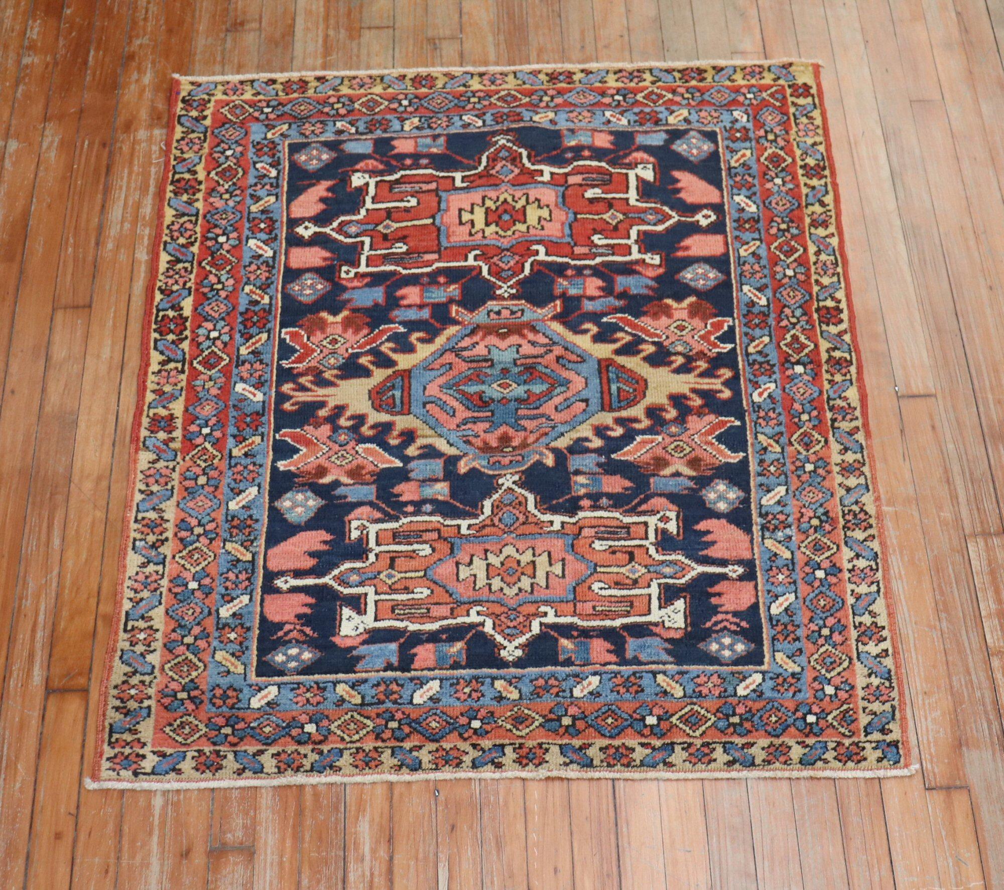 An early 20th-century traditional navy blue and brown square size Persian Heriz carpet.

Measures: 3'7