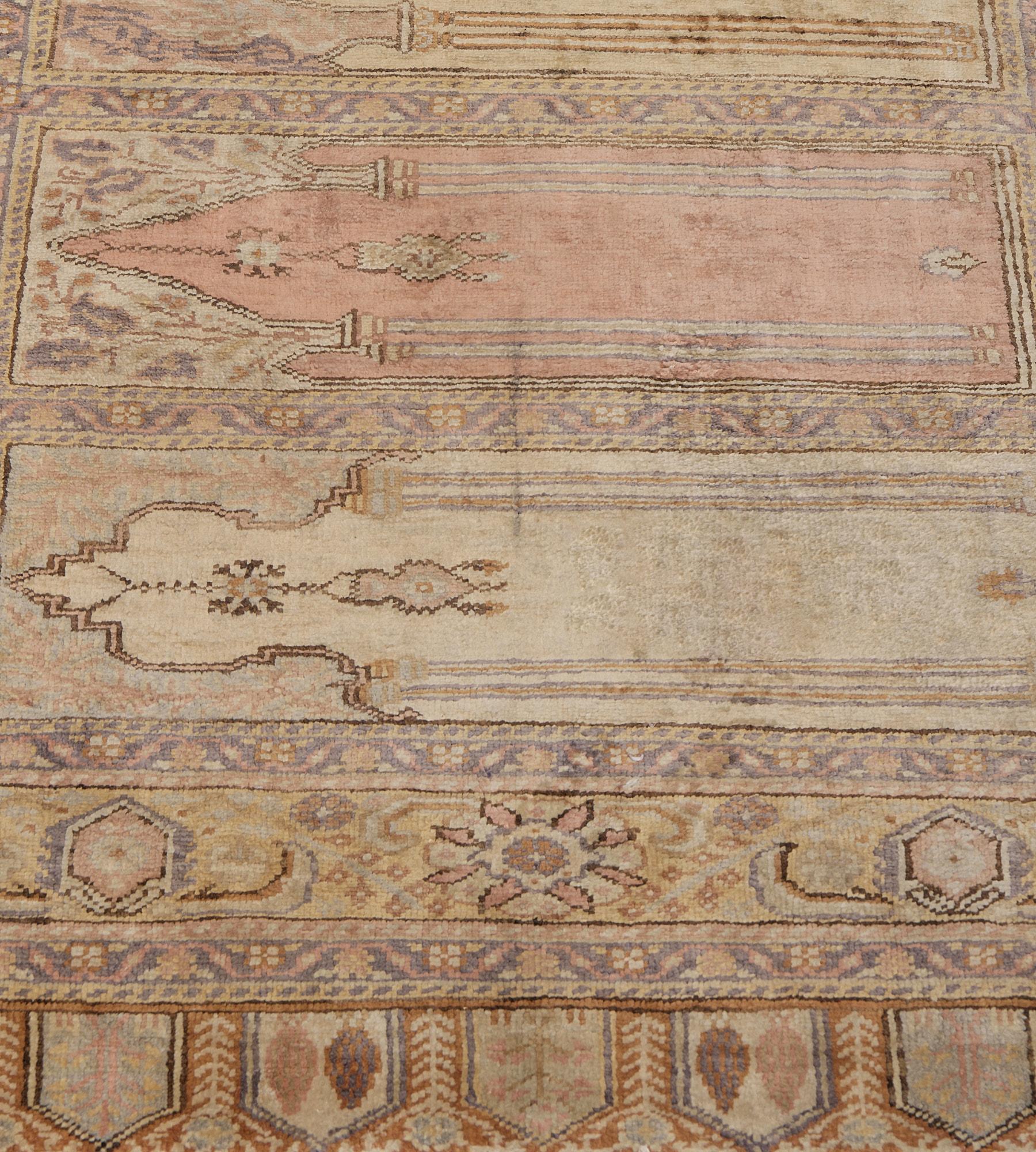 This antique, silk Turkish Kayseri runner has a field with ten polychrome panels each with a cusped arch above with delicate floral vine issuing vases in to the plain field below, in a broad golden-yellow border of linked turtle-palmette and