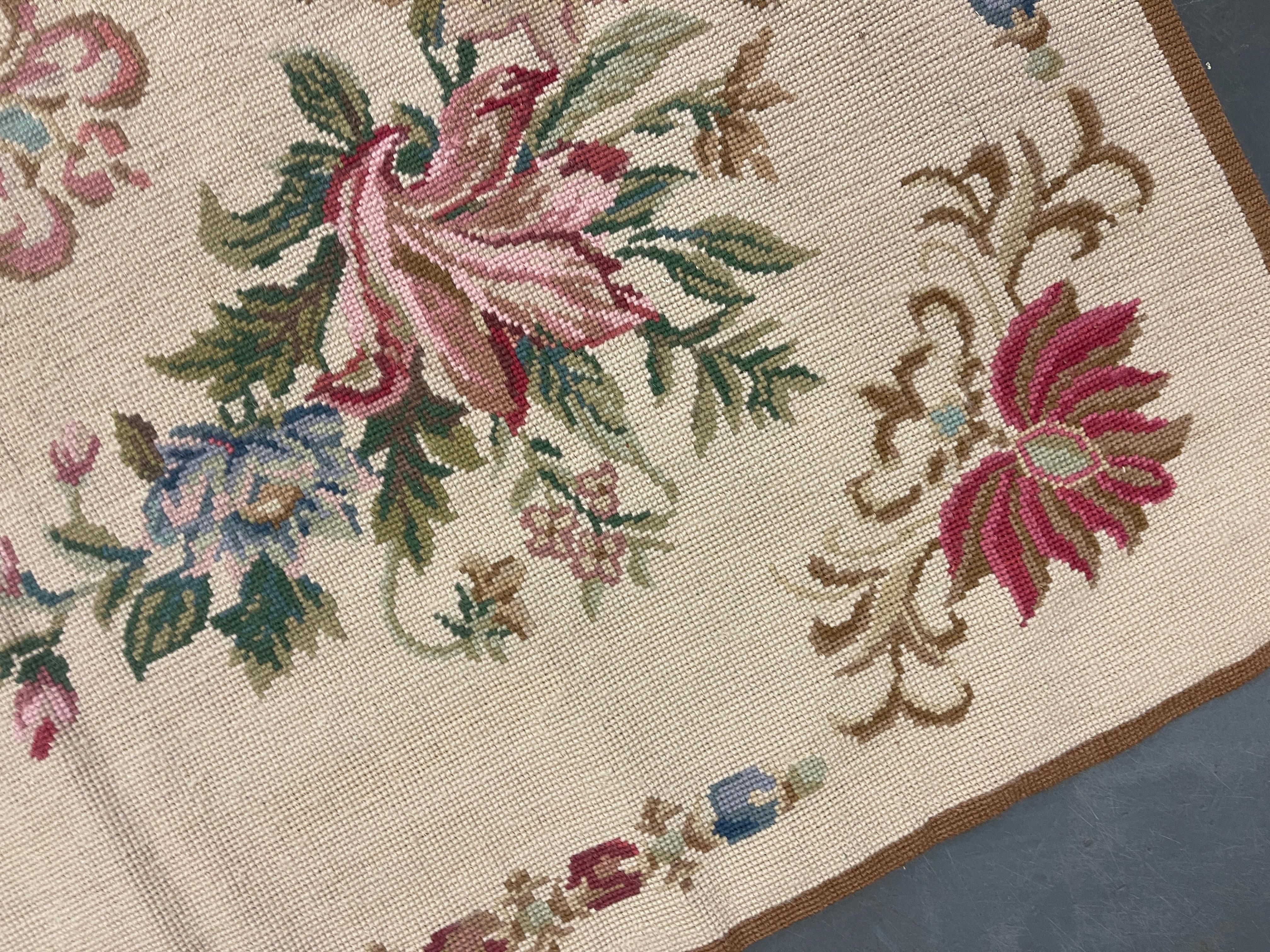 This fantastic large needlepoint rug has been handwoven with a beautiful repeat bunch of floral designs woven on an ivory blue background with cream-green and pink accents. This elegant piece's colour and design make it the perfect accent rug.
This