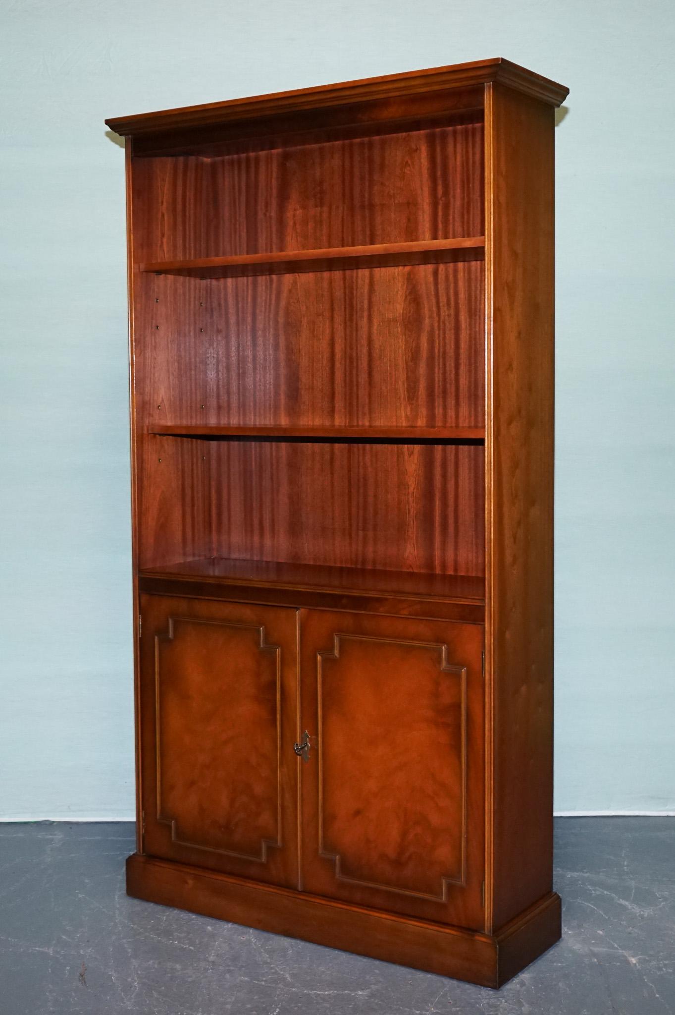 
Antiques of London

Elegant Bradley bookcase, crafted in England, featuring a rich hardwood finish. The bookcase has two adjustable open shelves above, perfect for books or display pieces, and a lower double-door cupboard for concealed storage.