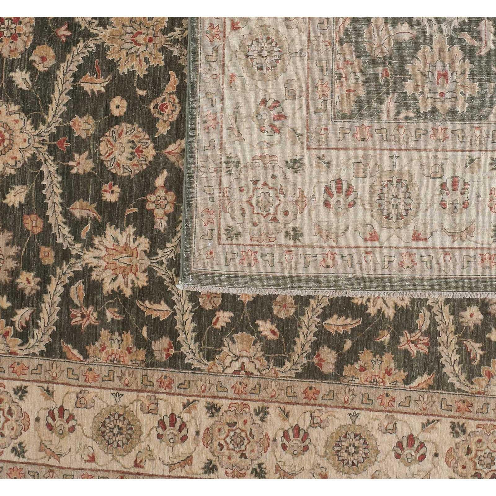 The floral elements of this traditional Pakistani design weave together seamlessly in a harmonious mix of color and pattern. Bold brown and red are offset by beige and coral tones. Wool. Hand knotted in Pakistan using vegetal dyes.