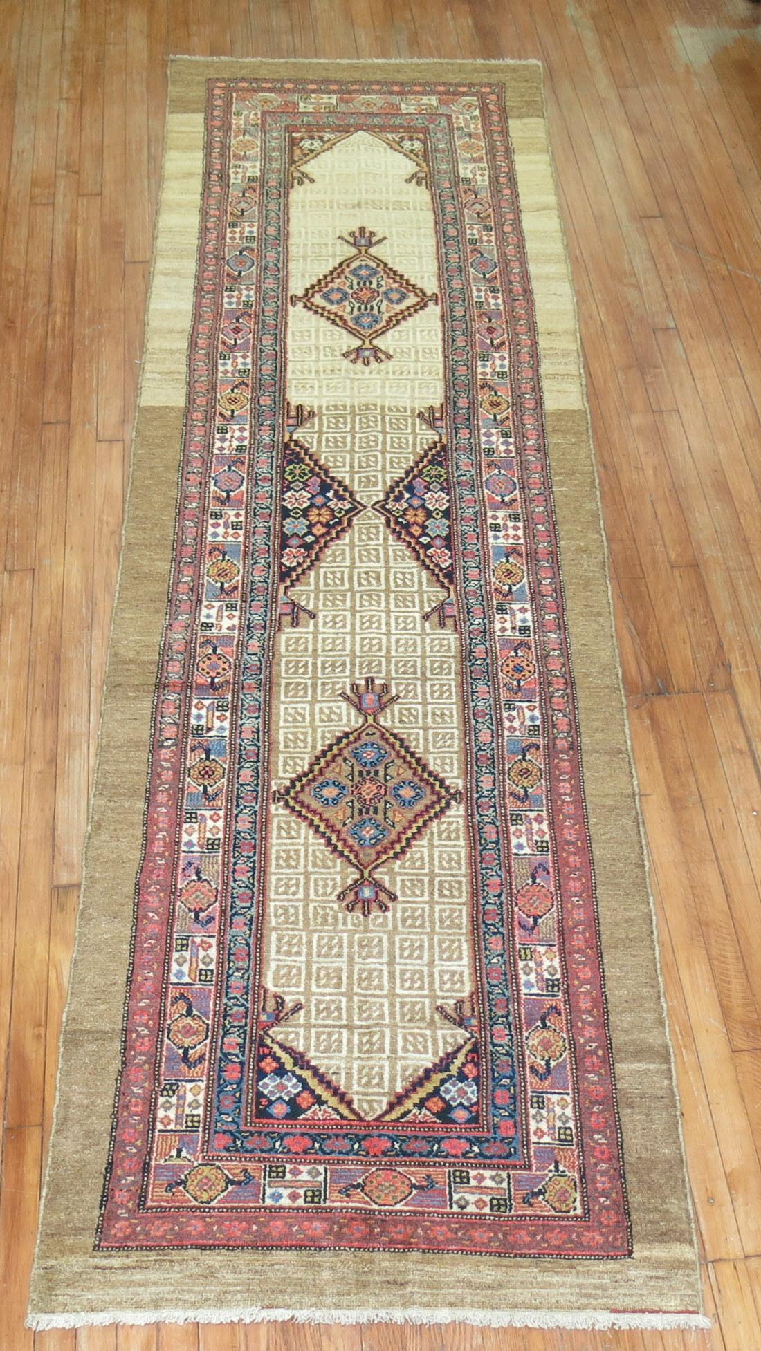 An authentic early 20th century Persian Serab runner with 2 geometric medallions on a camel field and multi-band border in rust, teal and ivory.

Measures: 3'2