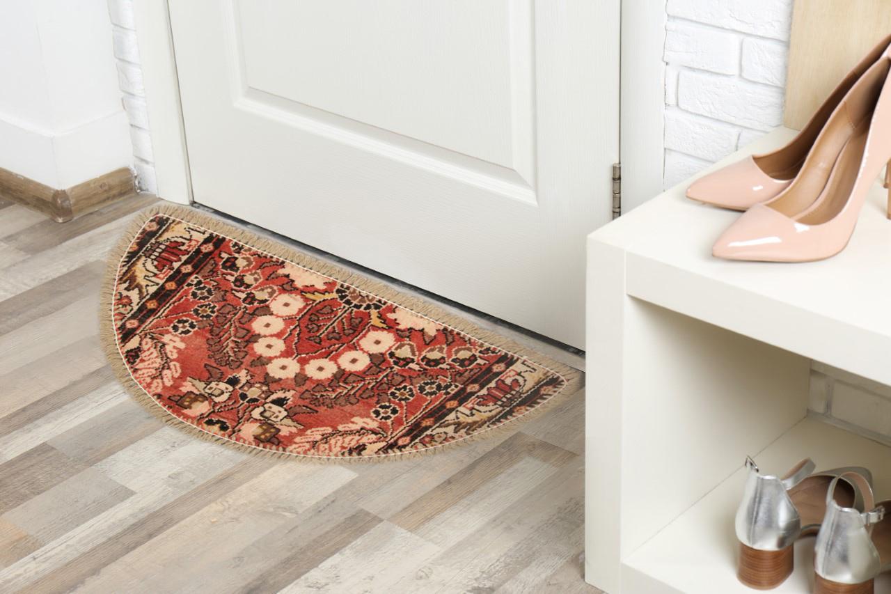 Featuring asymmetrical floral design on a peachy red background this pretty little Oriental rug is perfect for any doorway it is introduced to. This Semi-circle entranceway doormat has been refurbished from a handmade vintage rug- cut from large